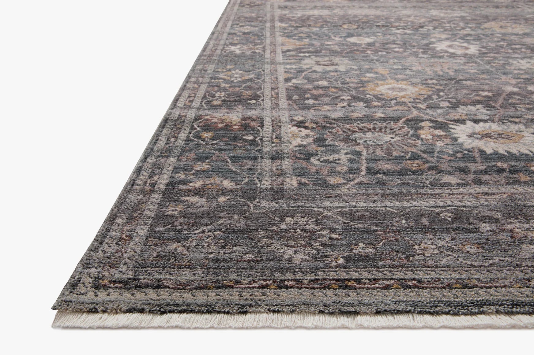 Ink blue-gray area rug with distressed medallion pattern and short fringed edge