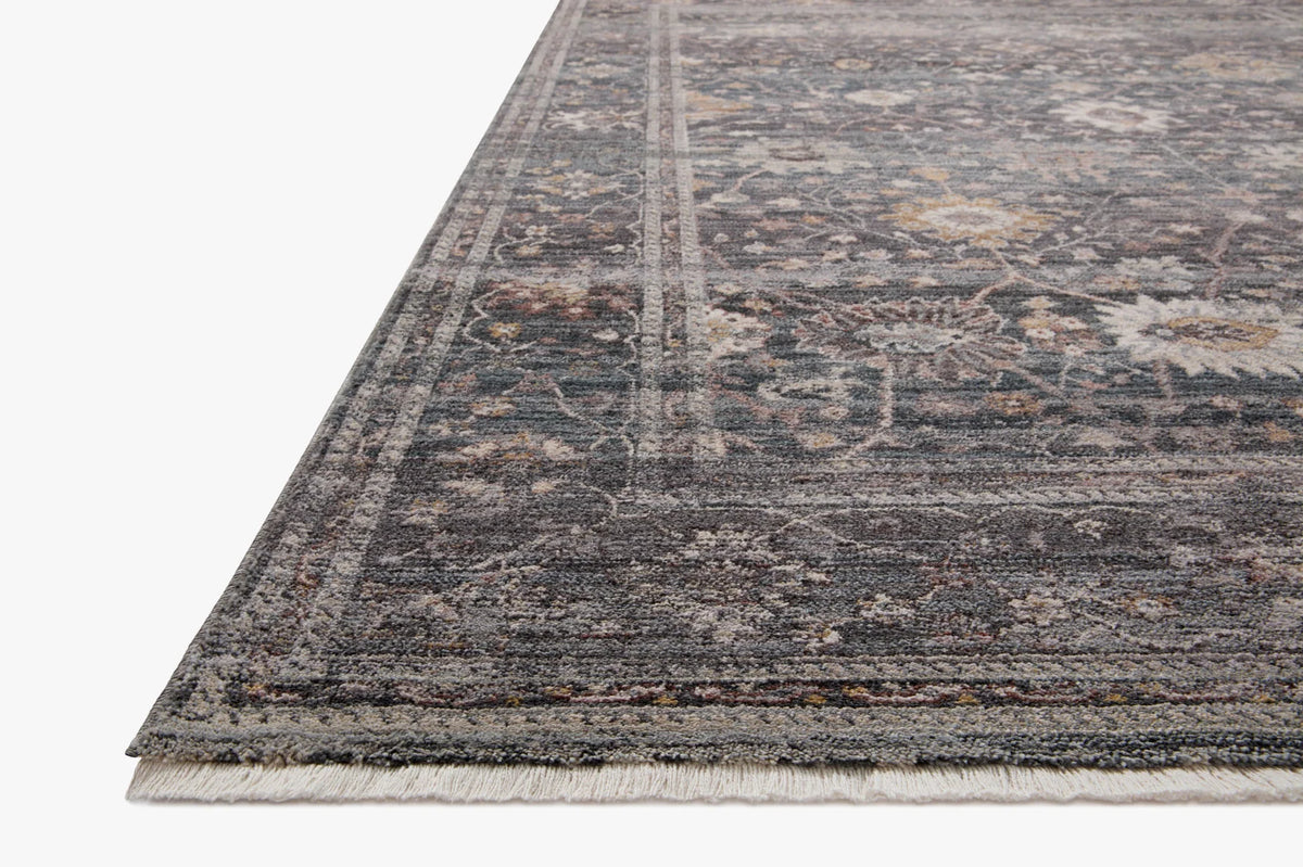 Accent rug with distressed medallion pattern in dark navy, gray, and beige; short fringe