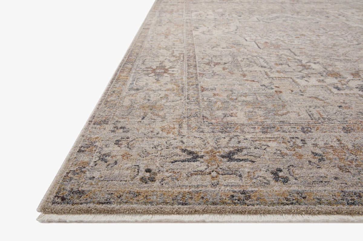 Natural and gold area rug with distressed abstract pattern and short fringe border