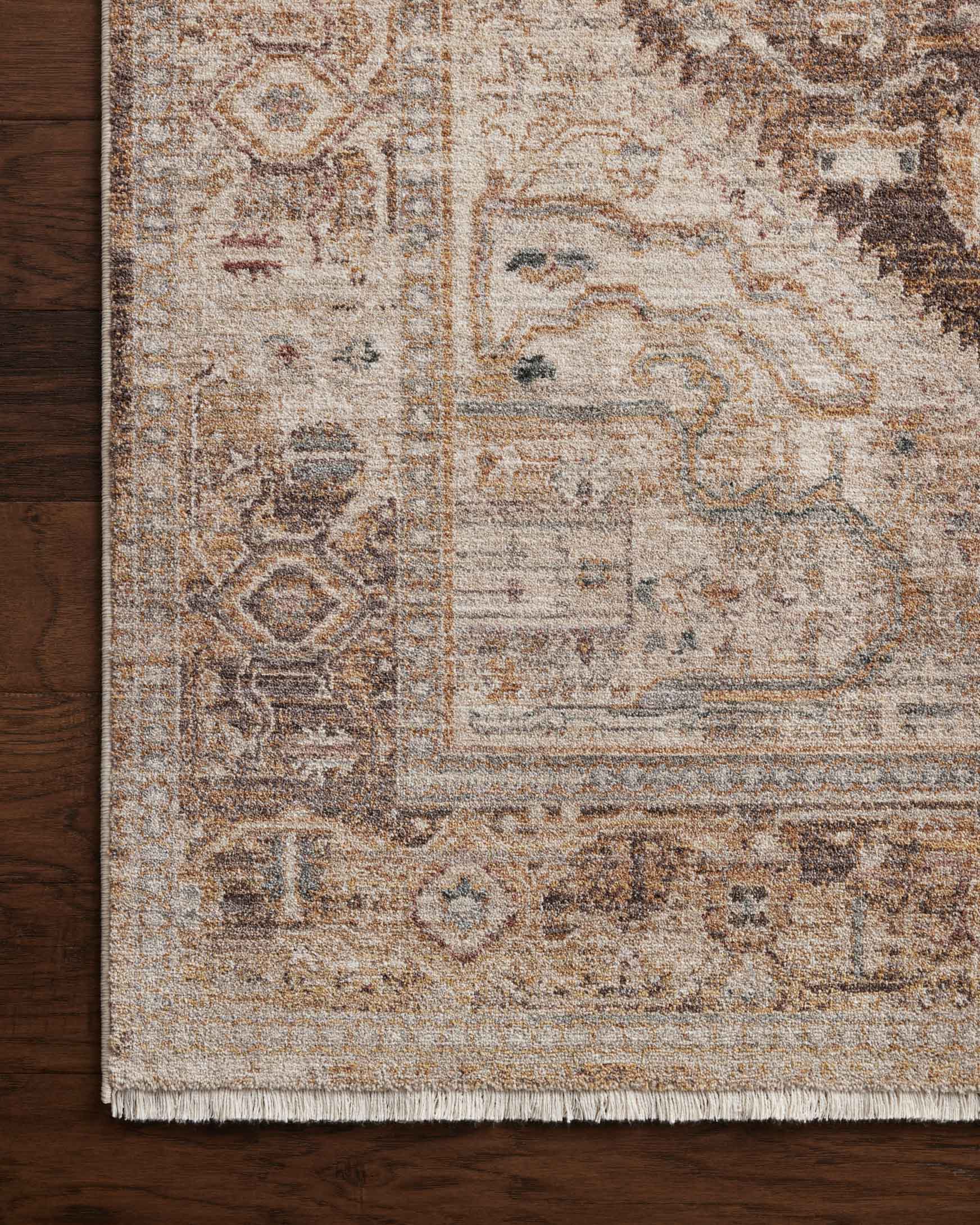 Close-up natural and mocha runner rug with detailed distressed scrollwork pattern