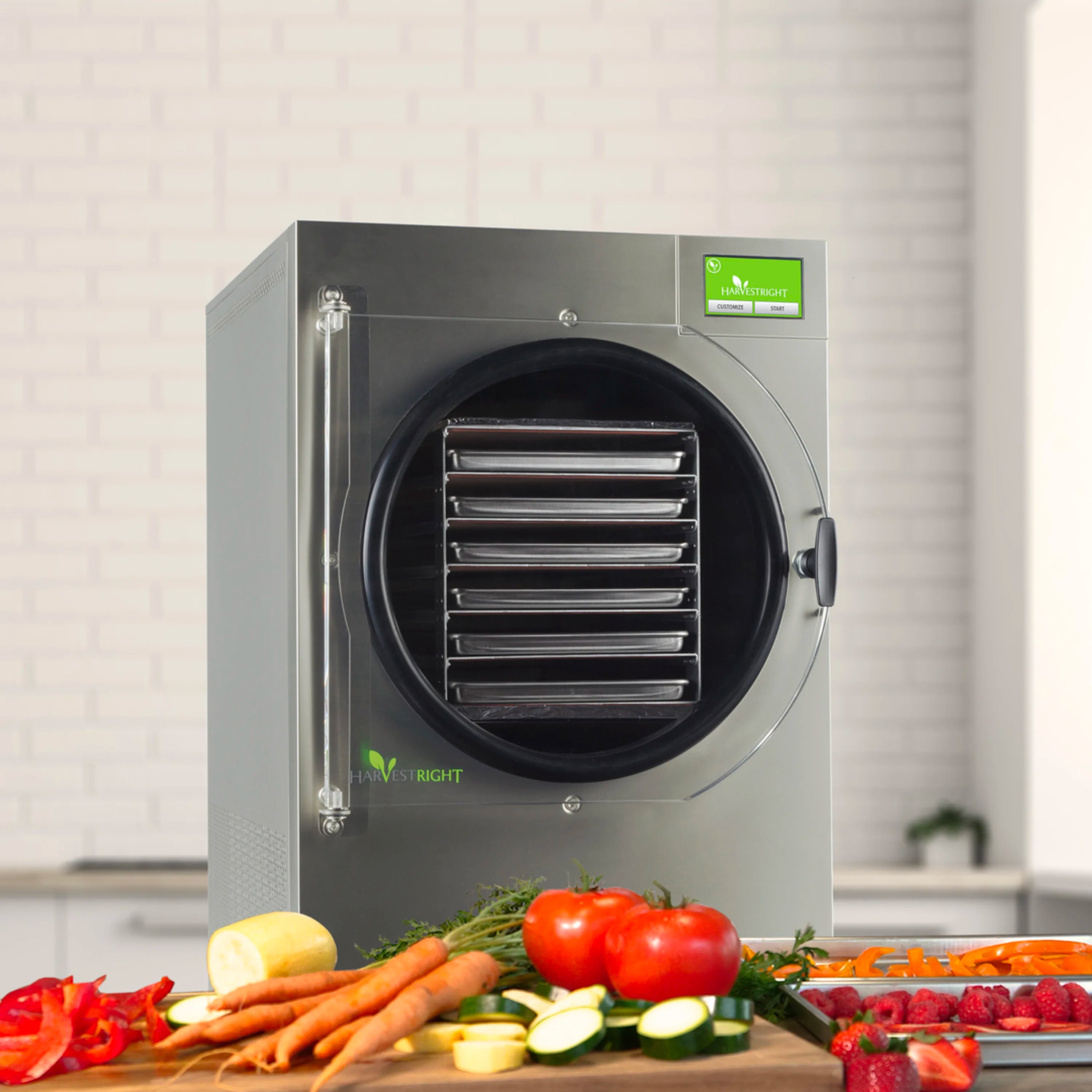 Stainless steel freeze dryer with round door, with vegetables on the counter