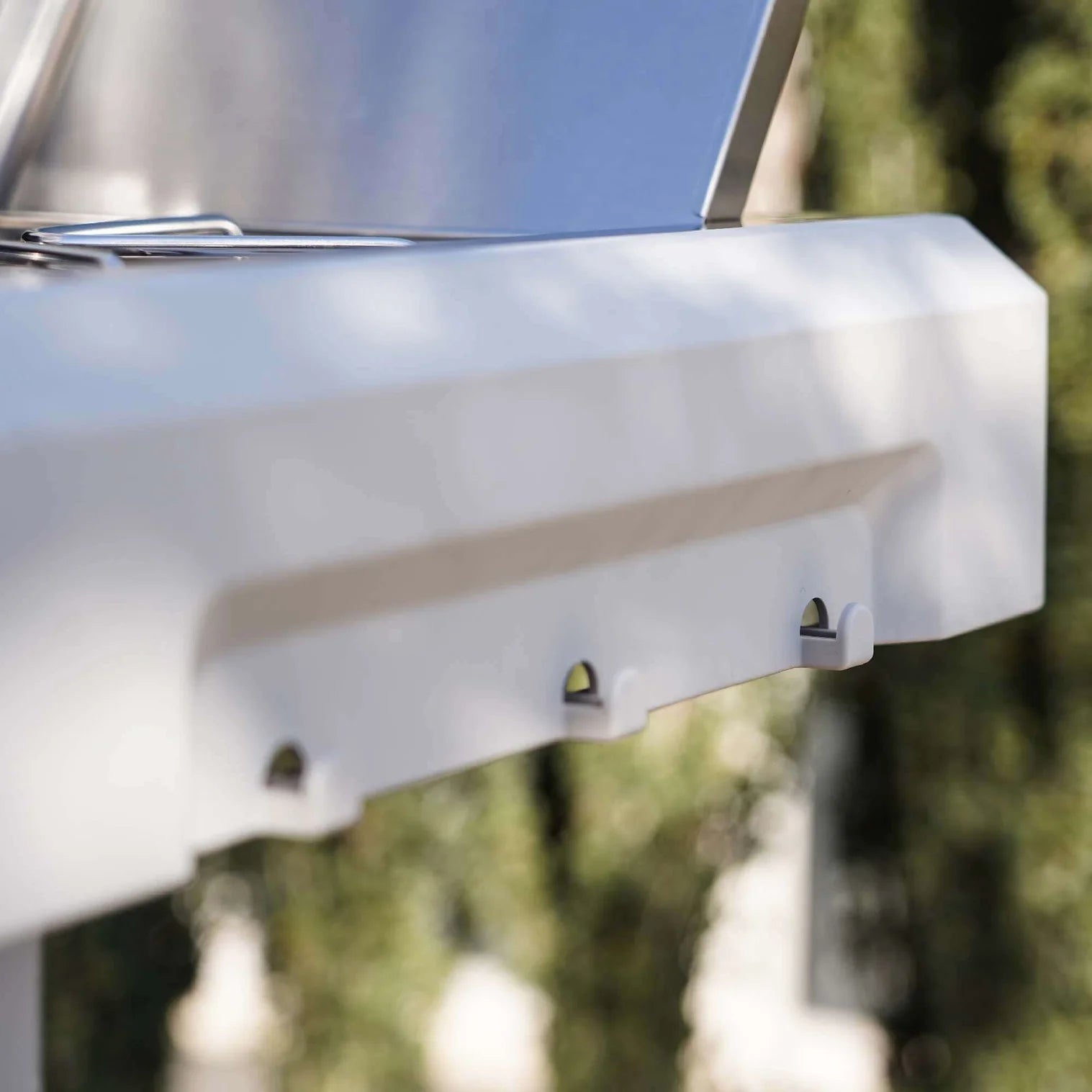 White-propane? no, stainless steel grill body corner with side vent and handle detail