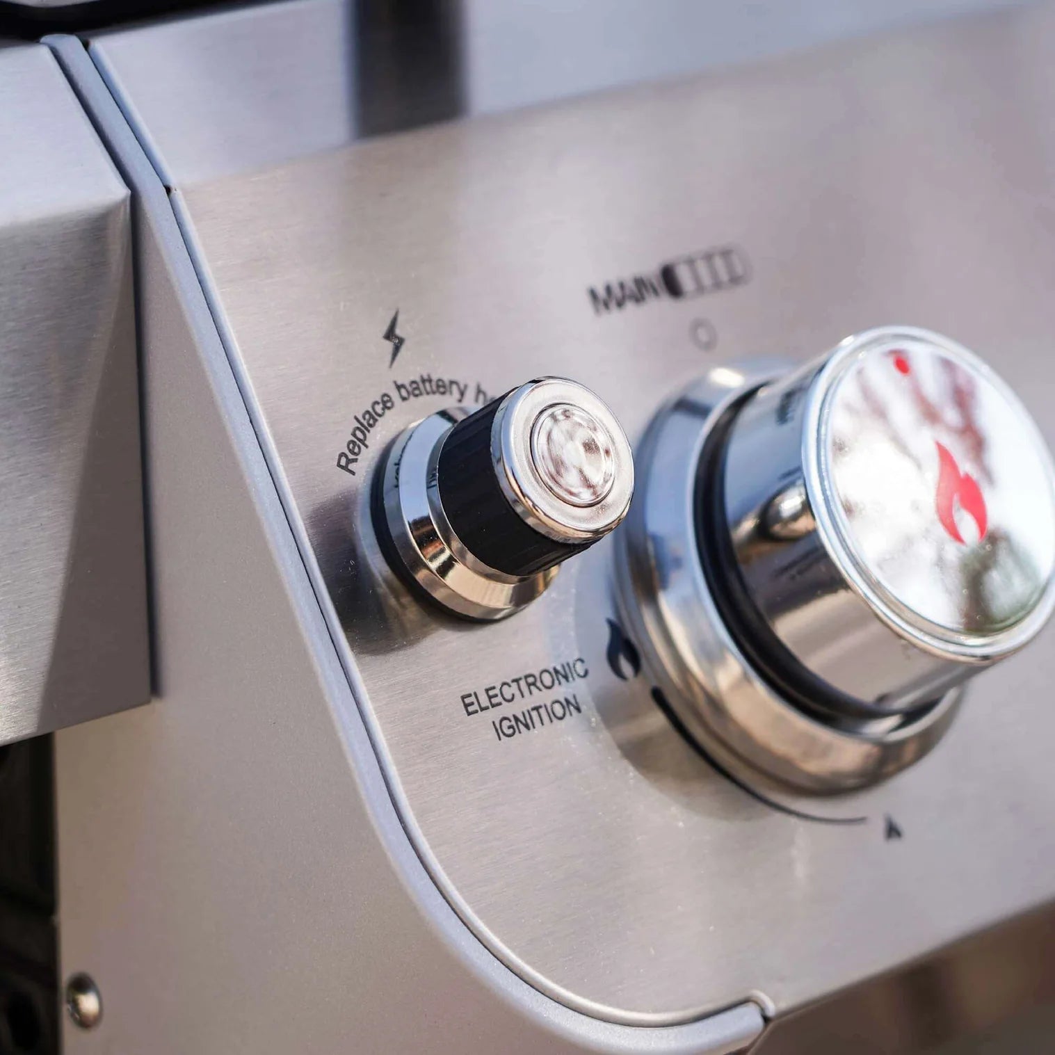 Stainless steel grill control panel with electronic ignition and temperature icons