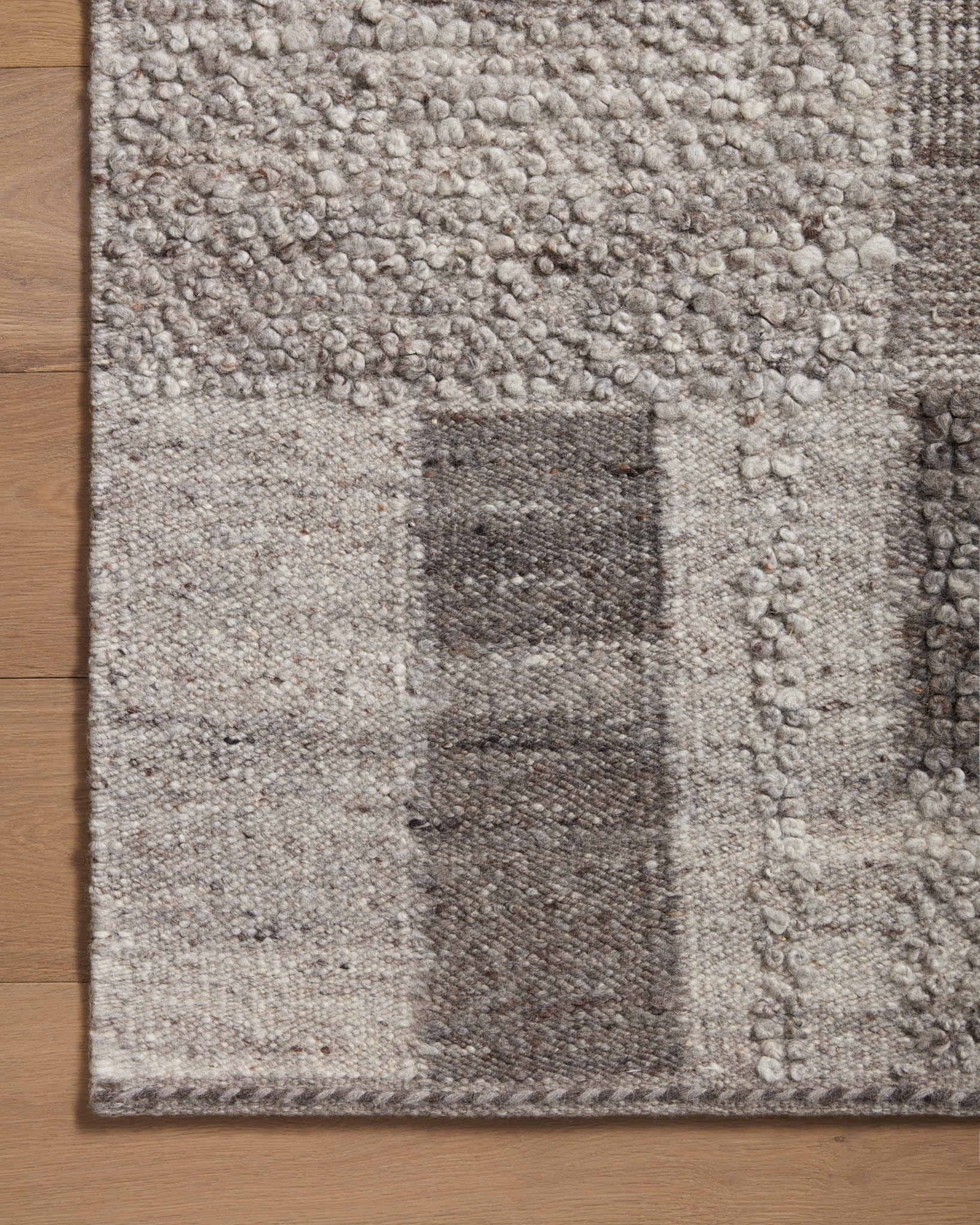 Charcoal and dove accent rug close-up, raised loop texture and square tile pattern
