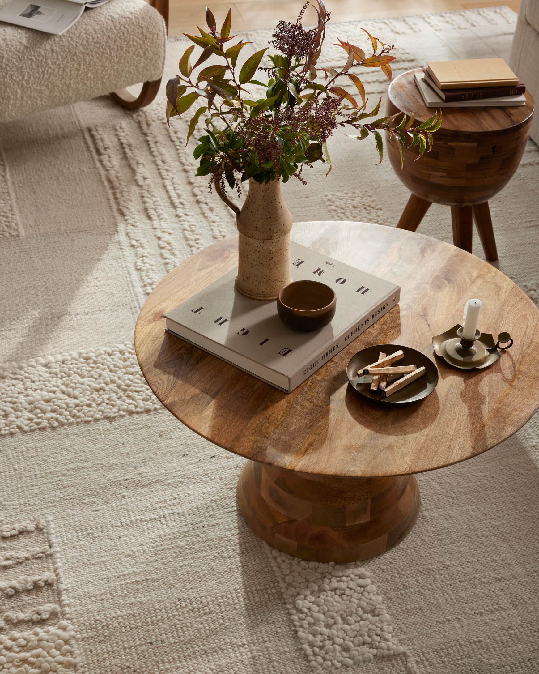 Ivory and pebble textured area rug with patchwork pattern and raised texture