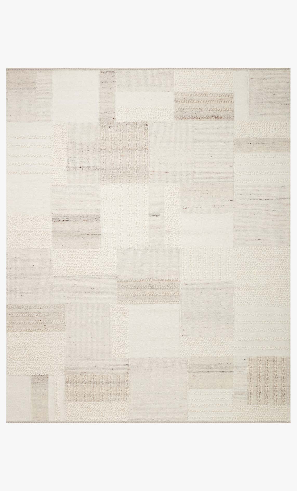 Ivory and pebble area rug with patchwork block design and textured shag surface