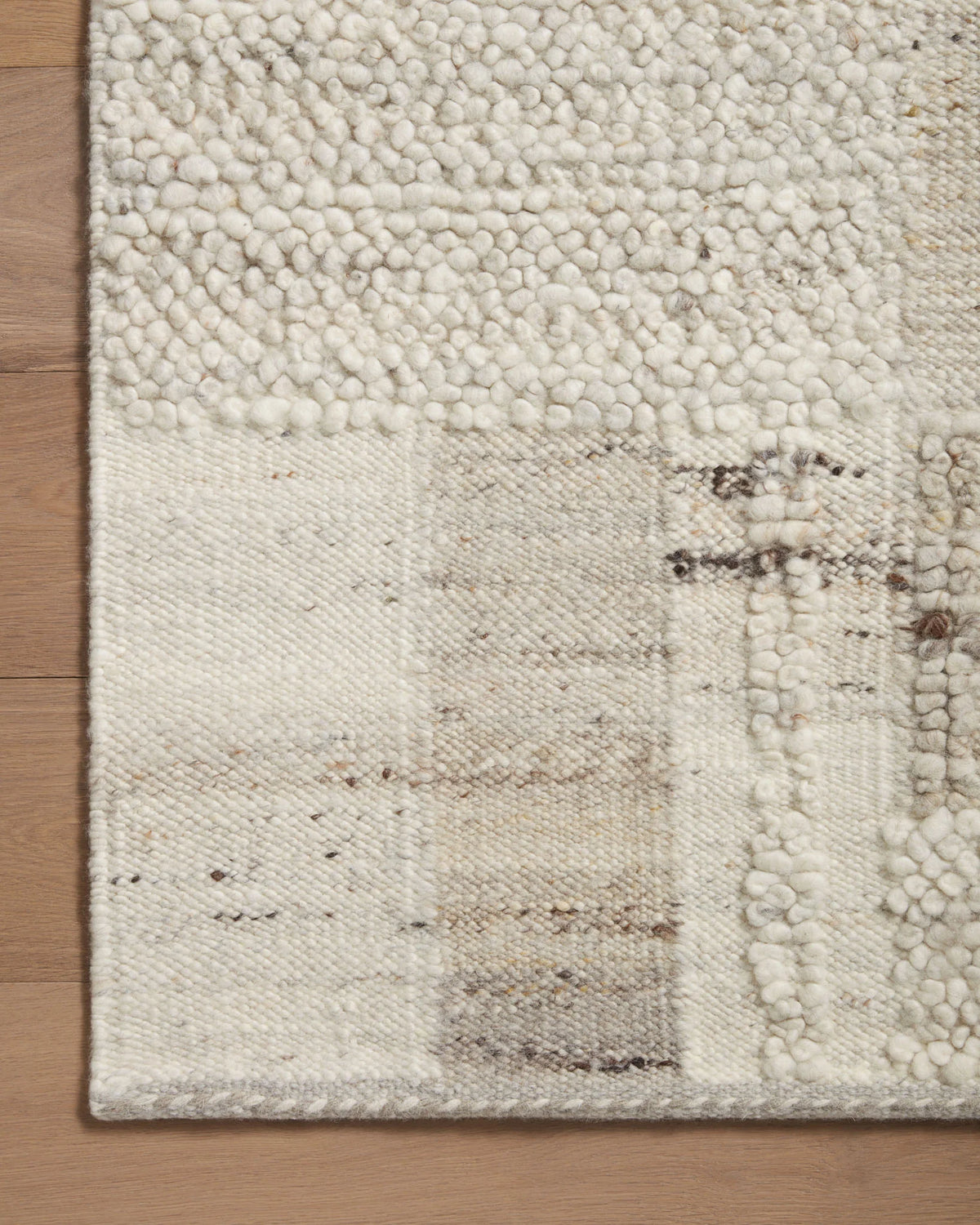 Looped pile accent rug in natural beige with stone-gray patchwork squares