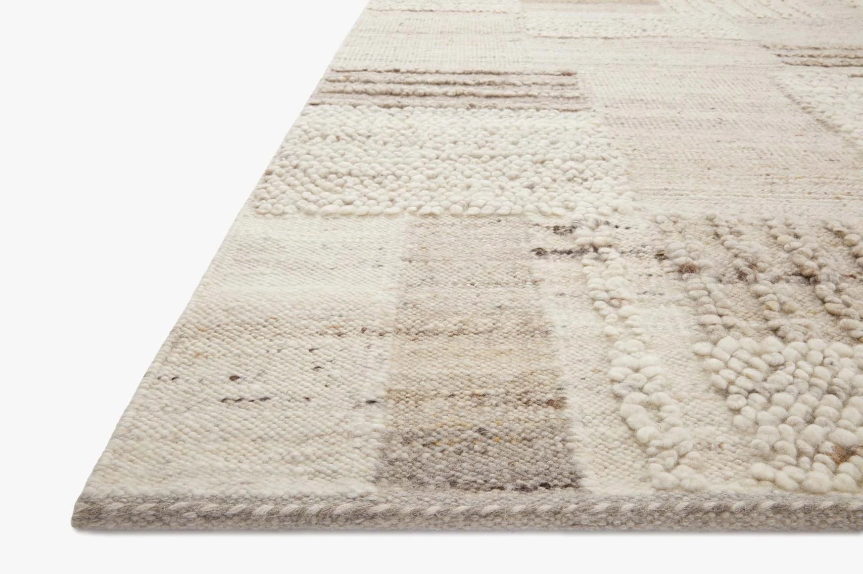 Natural beige and stone gray woven area rug with patchwork blocks and textured loops
