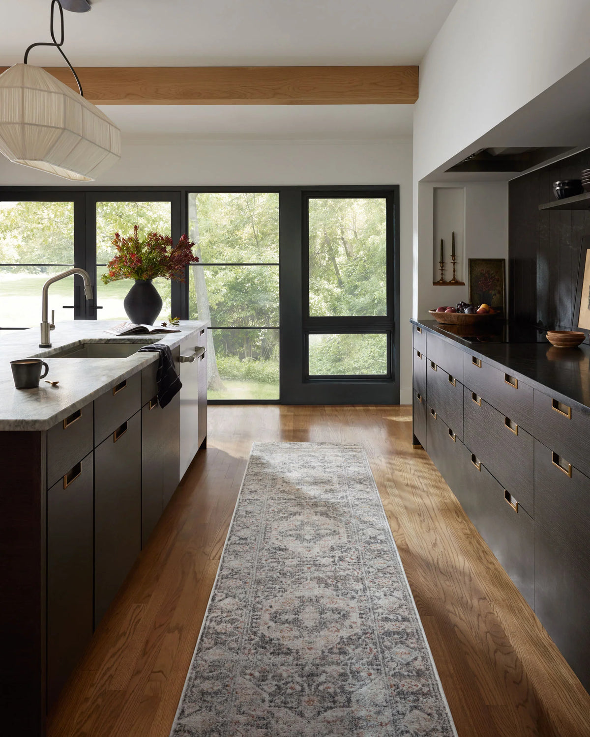 Charcoal and light gray abstract runner-style area rug on wood floor in living room.