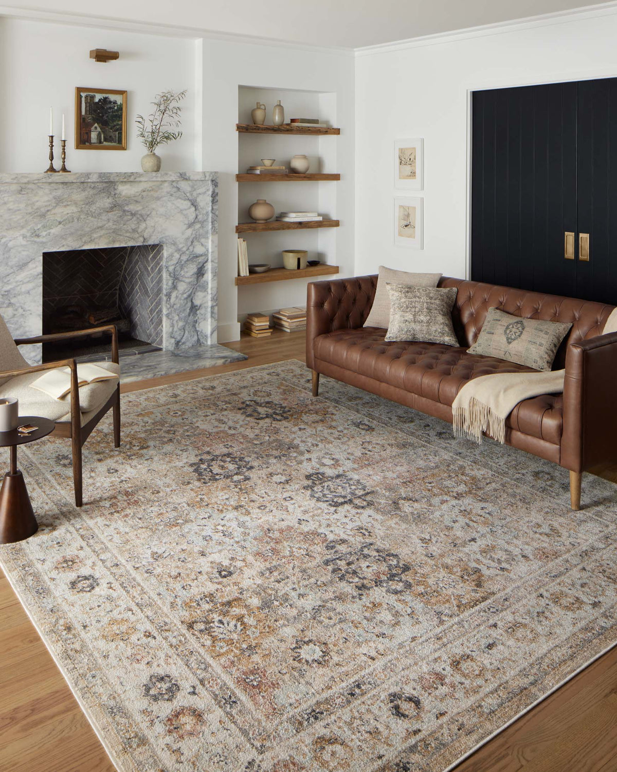 Beige runner rug with distressed blue-brown and orange motif pattern, bordered edge