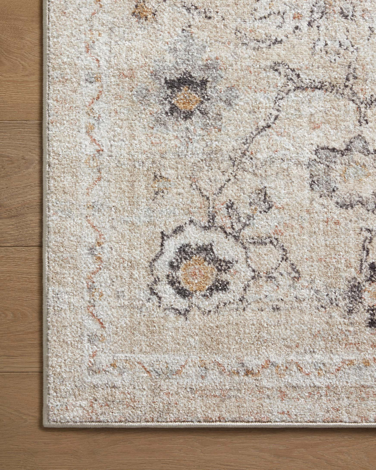 Beige and gray distressed area rug with floral medallion motif and worn detailing
