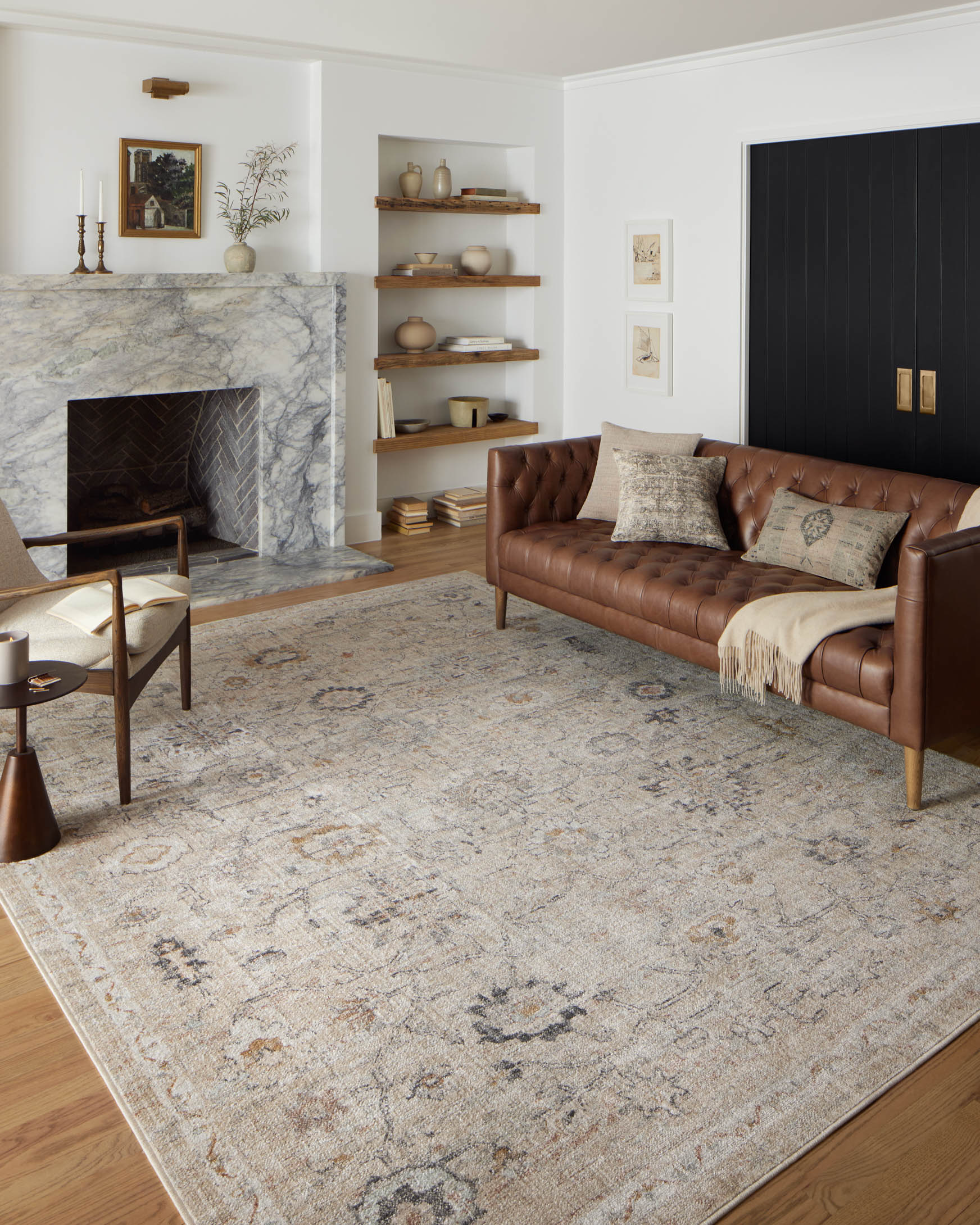 Natural area rug with distressed pattern in beige and gray, styled in a living room