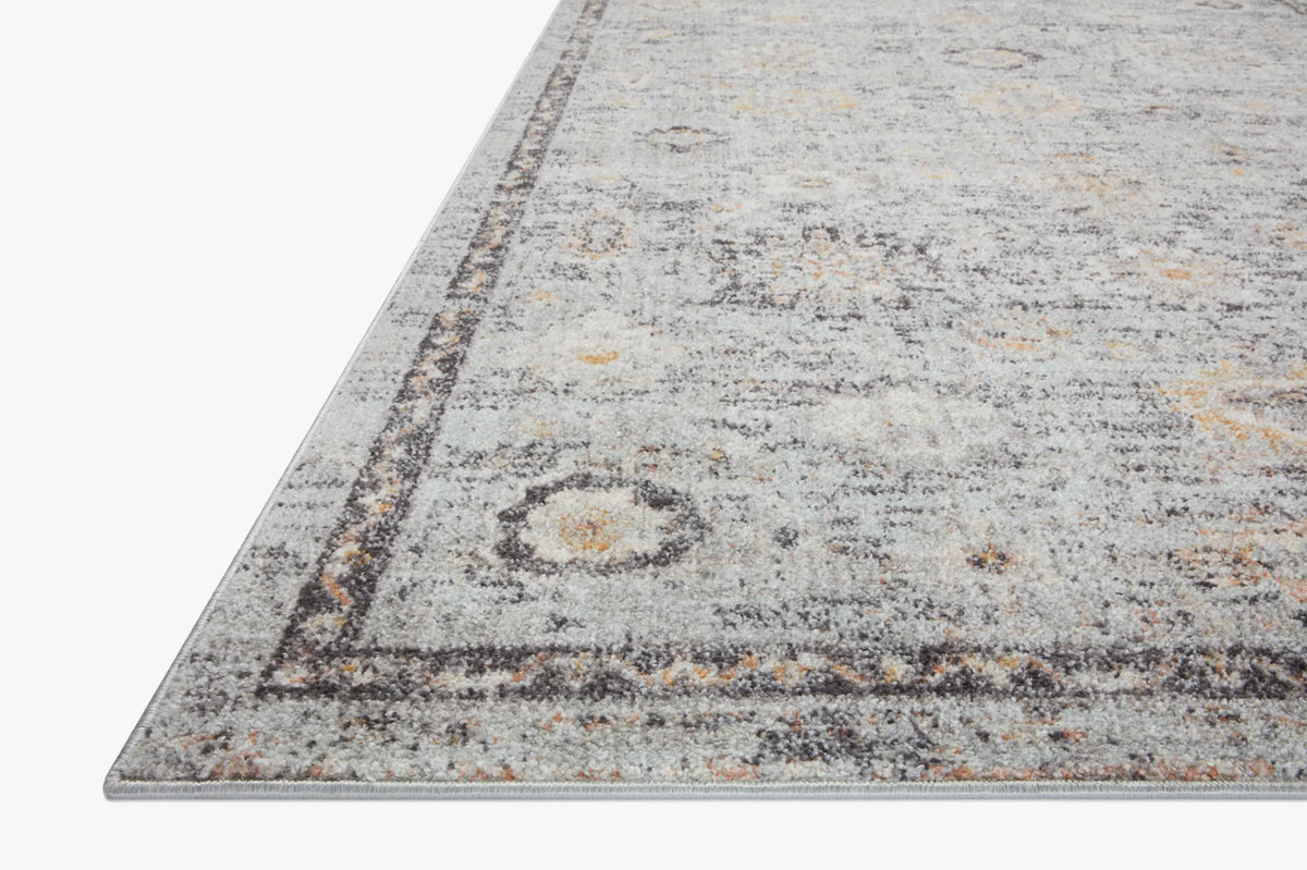 Light gray area rug with distressed abstract pattern and dark border