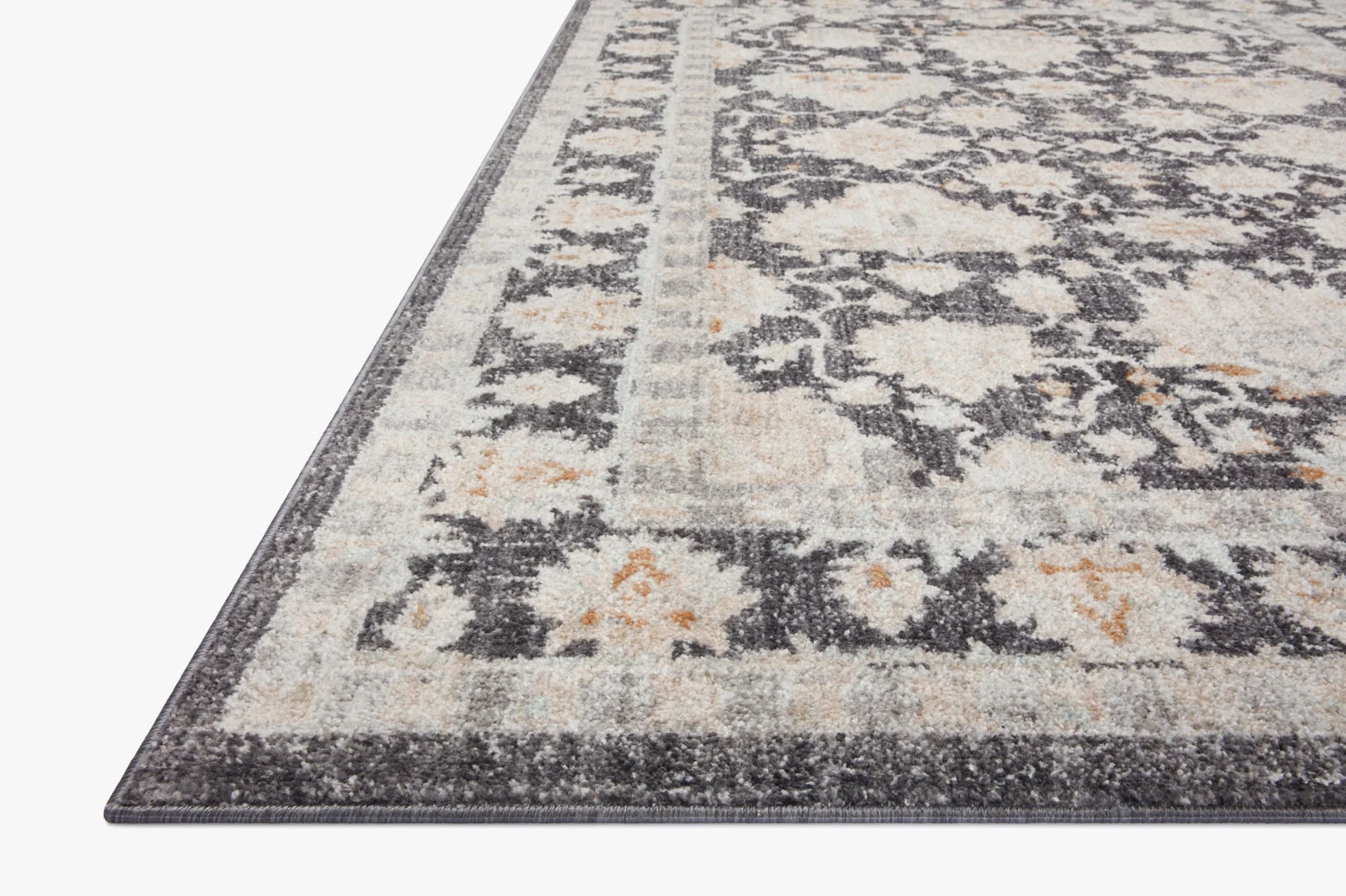 Charcoal and natural area rug with vintage-style medallion pattern and dark border