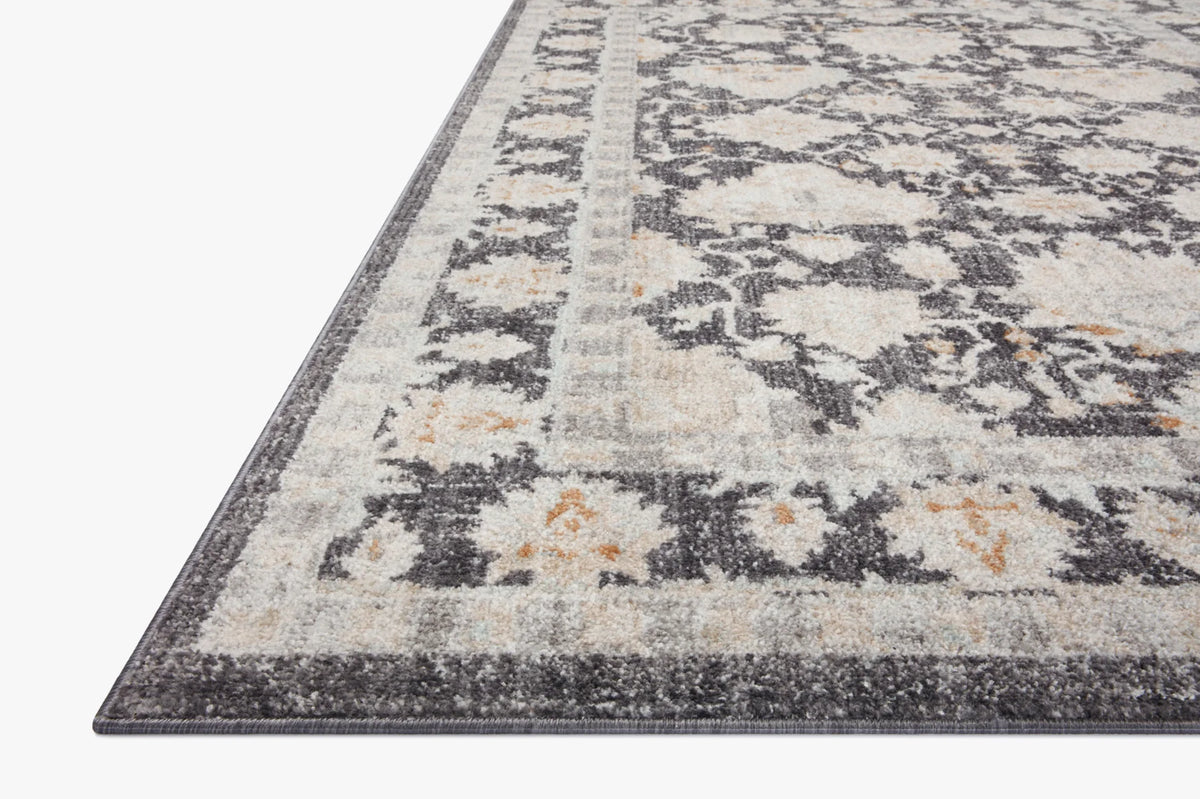 Charcoal and natural patterned area rug with distressed abstract medallion design