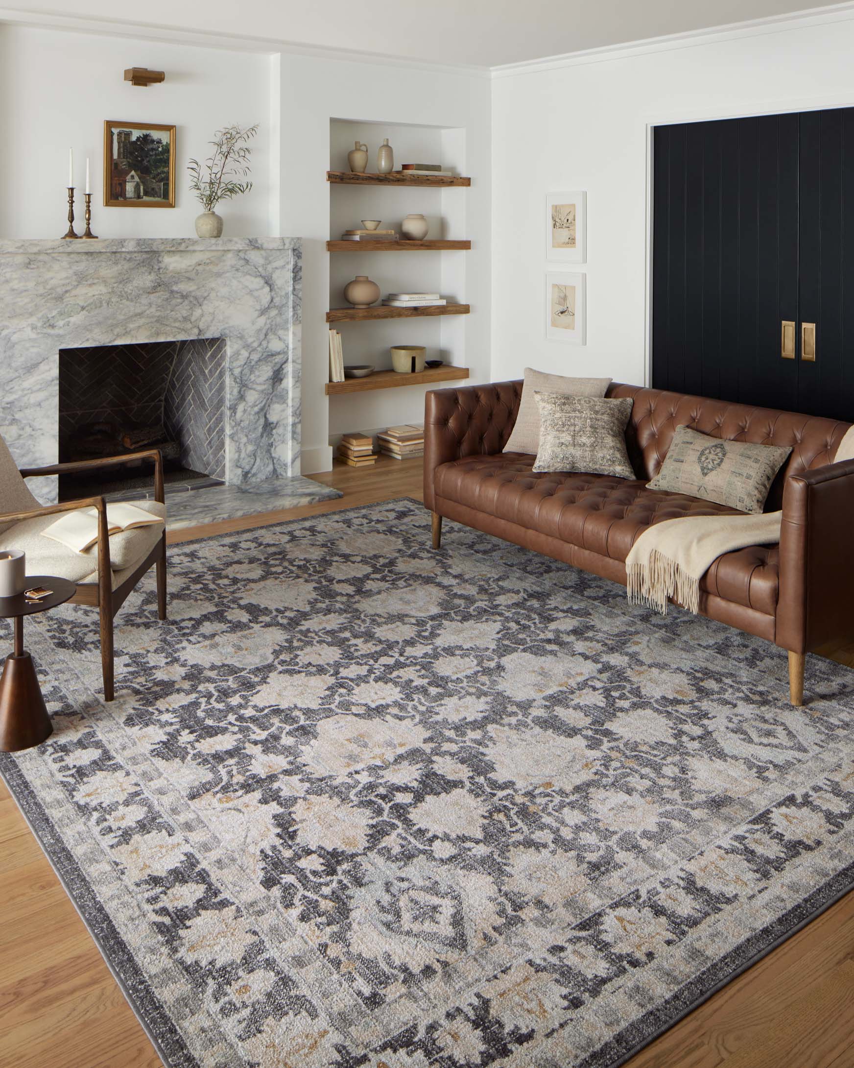 Charcoal and natural distressed area rug with ornate damask motifs and bordered edge.