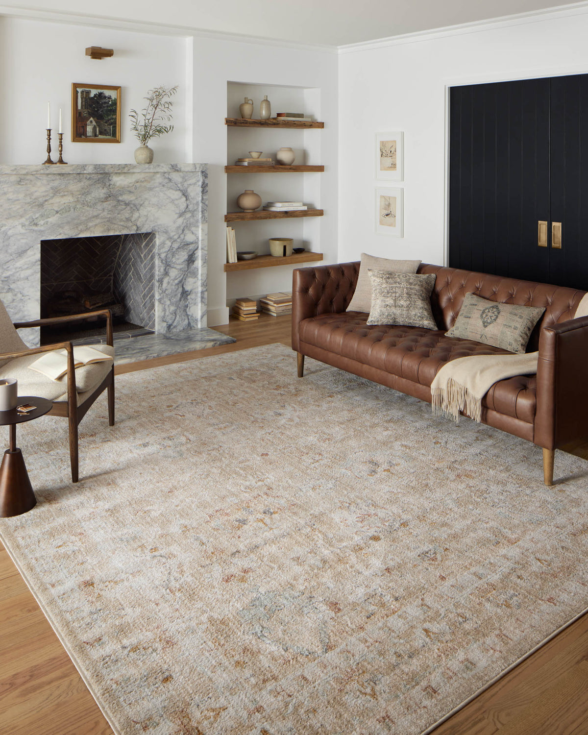Sand area rug with distressed mottled pattern and rust-orange and light blue specks