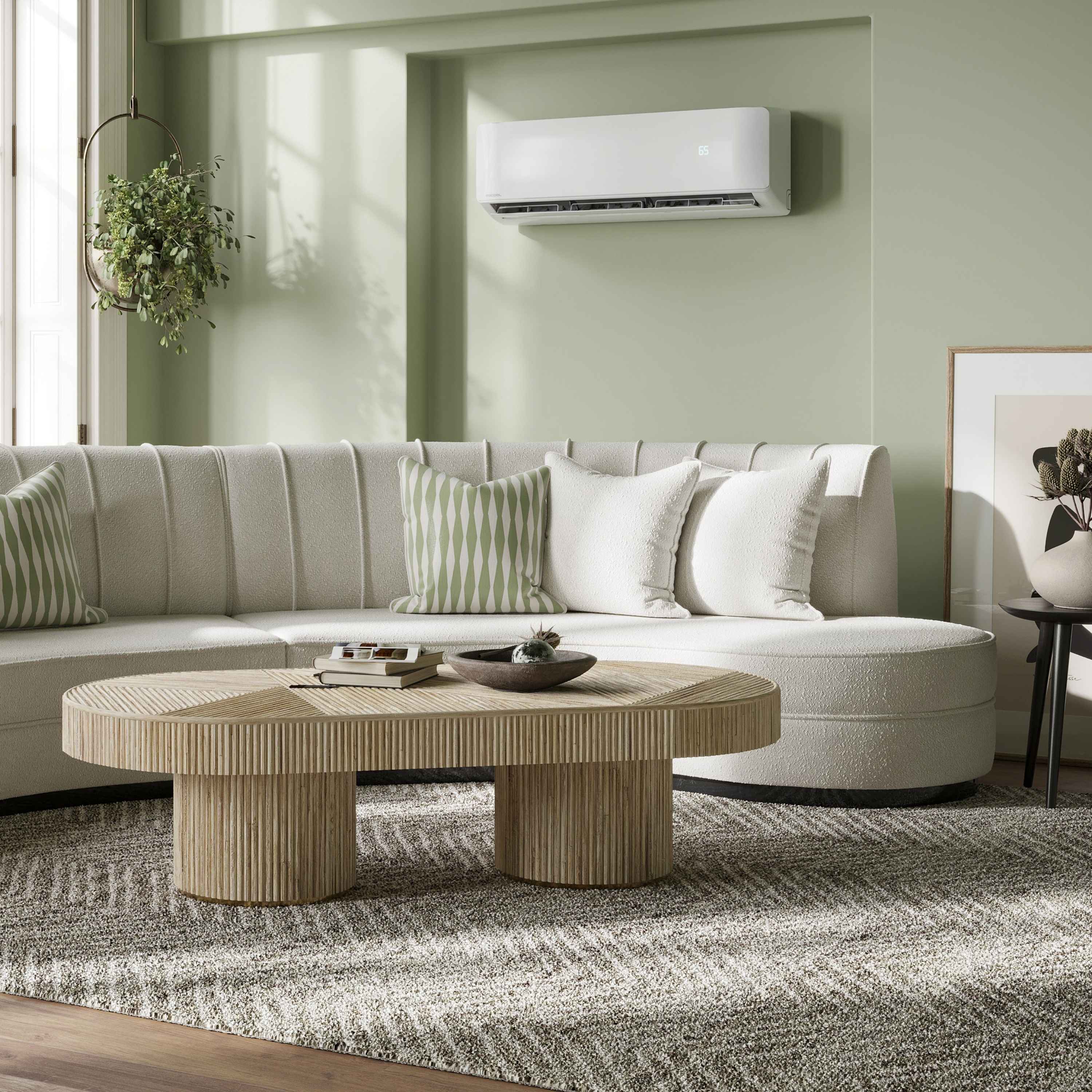 Wall-mounted mini split air conditioner with indoor unit above a sofa in a room