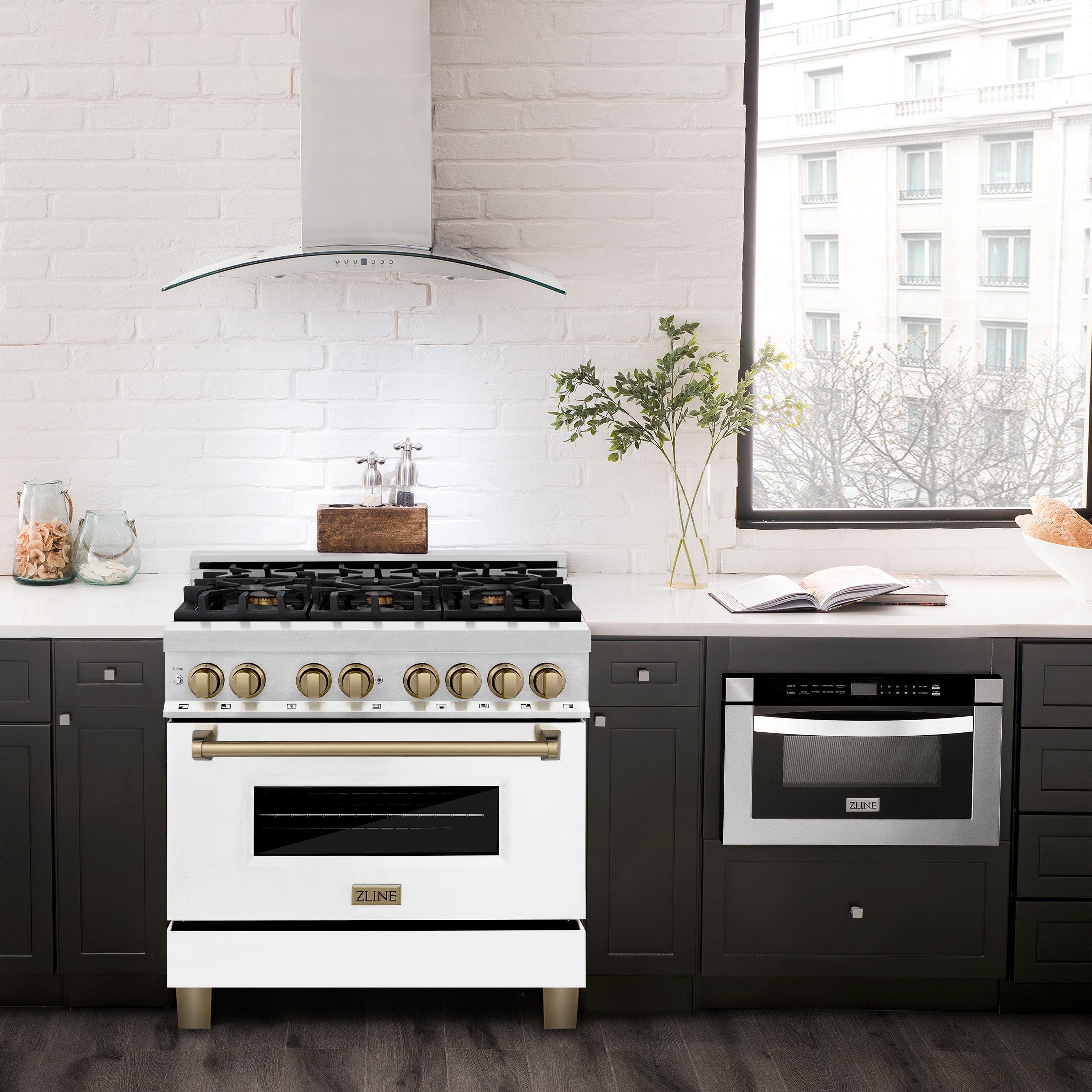 Stainless dual fuel range with white oven doors and gold burner knobs in kitchen