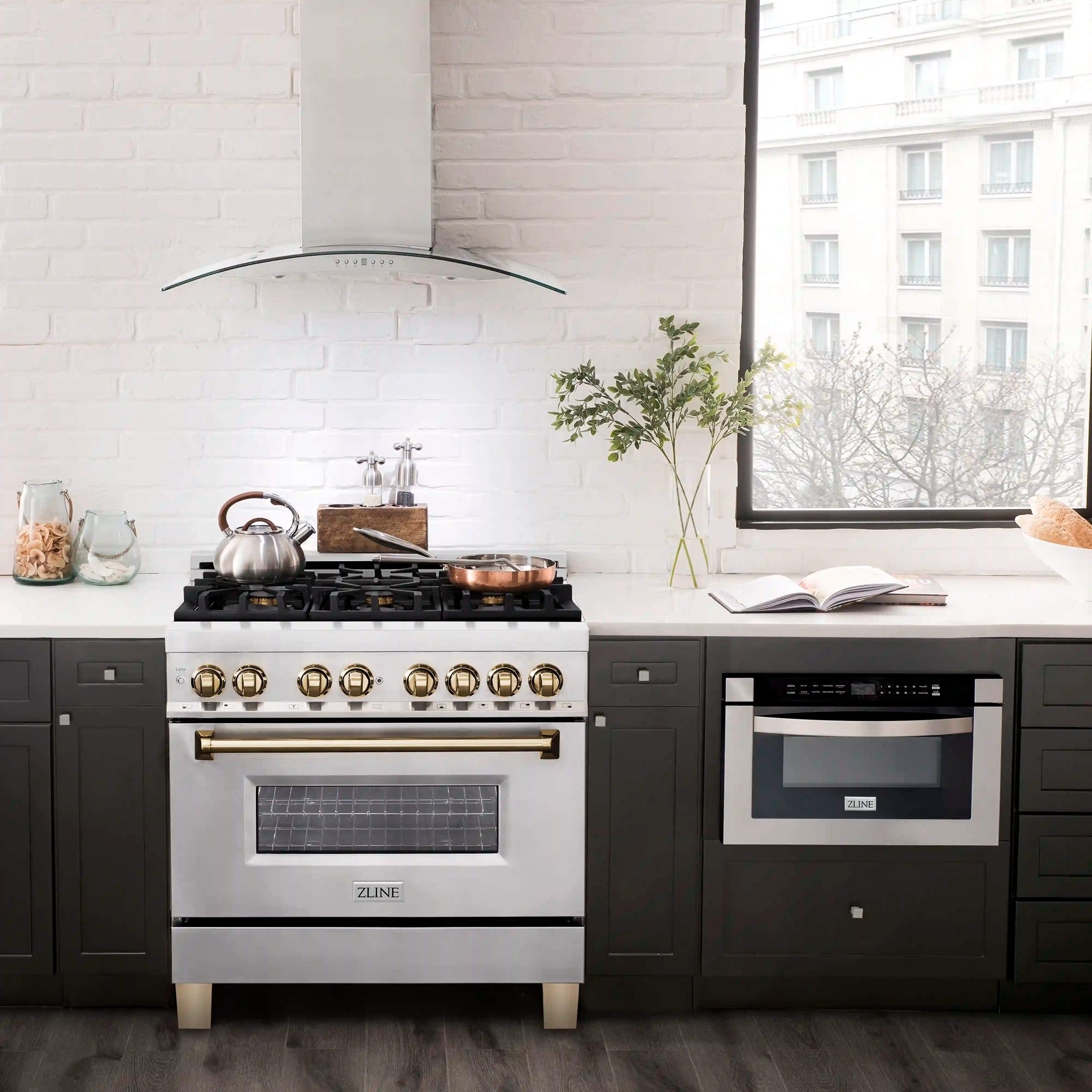 Stainless dual fuel range with gold-accent controls and a glass oven door