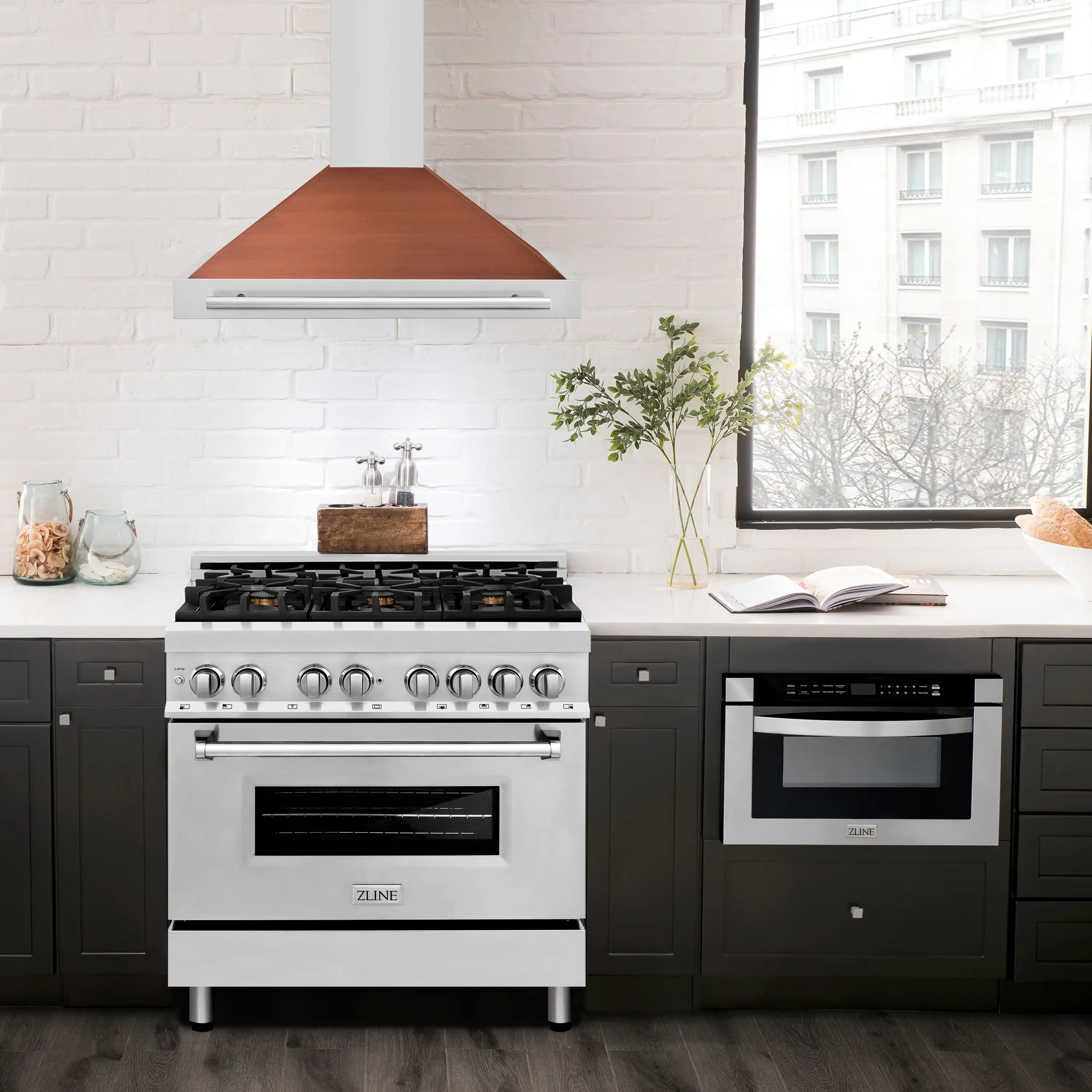Stainless range hood with white chimney and copper-toned canopy above gas range