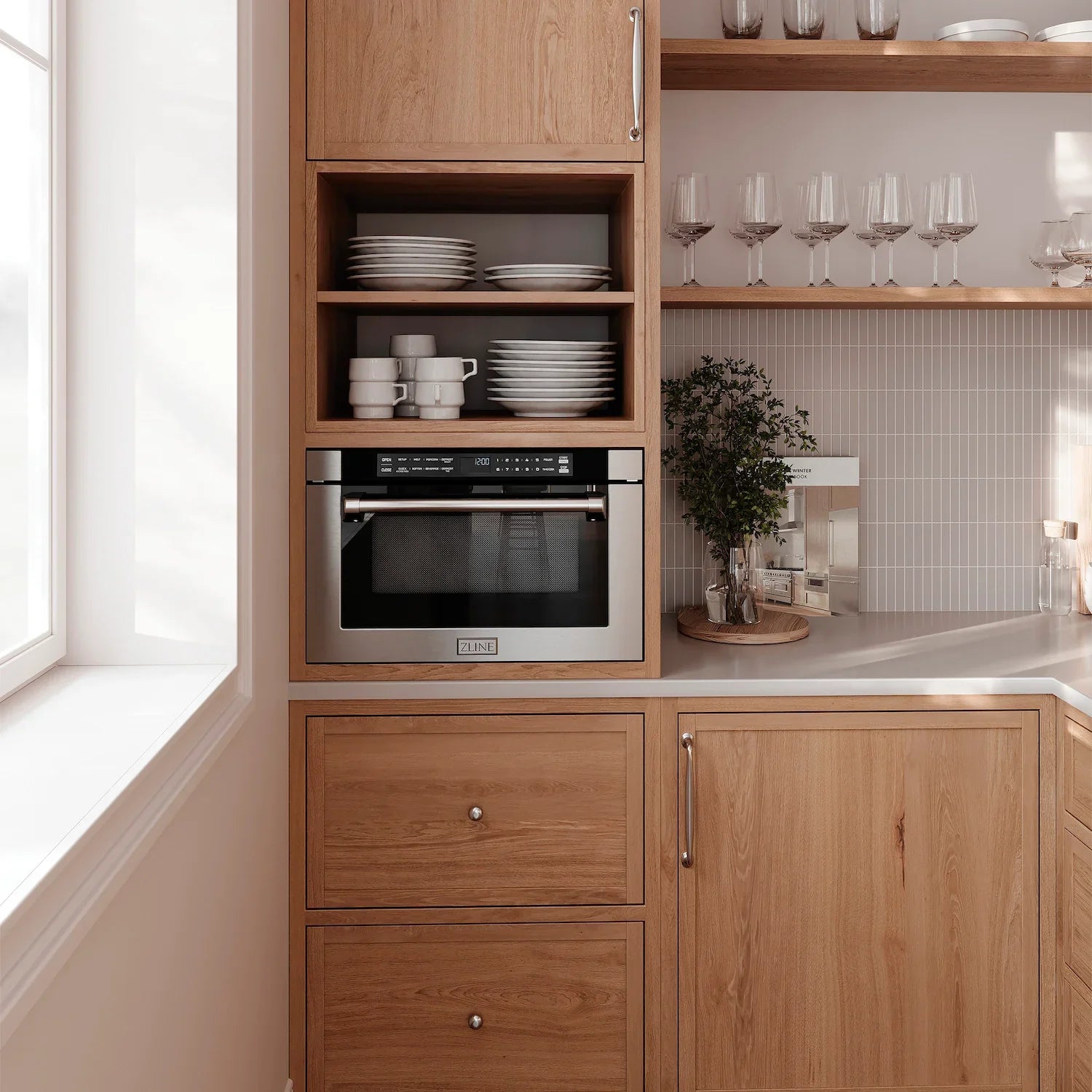 Built-in oven compartment with black glass door, framed by light wood panels