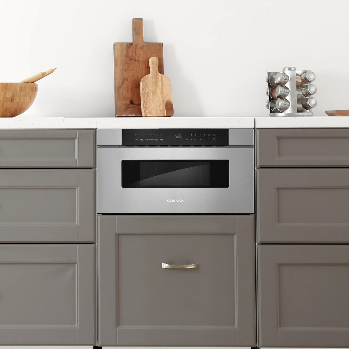 Stainless steel built-in microwave drawer with dark window, integrated into cabinet
