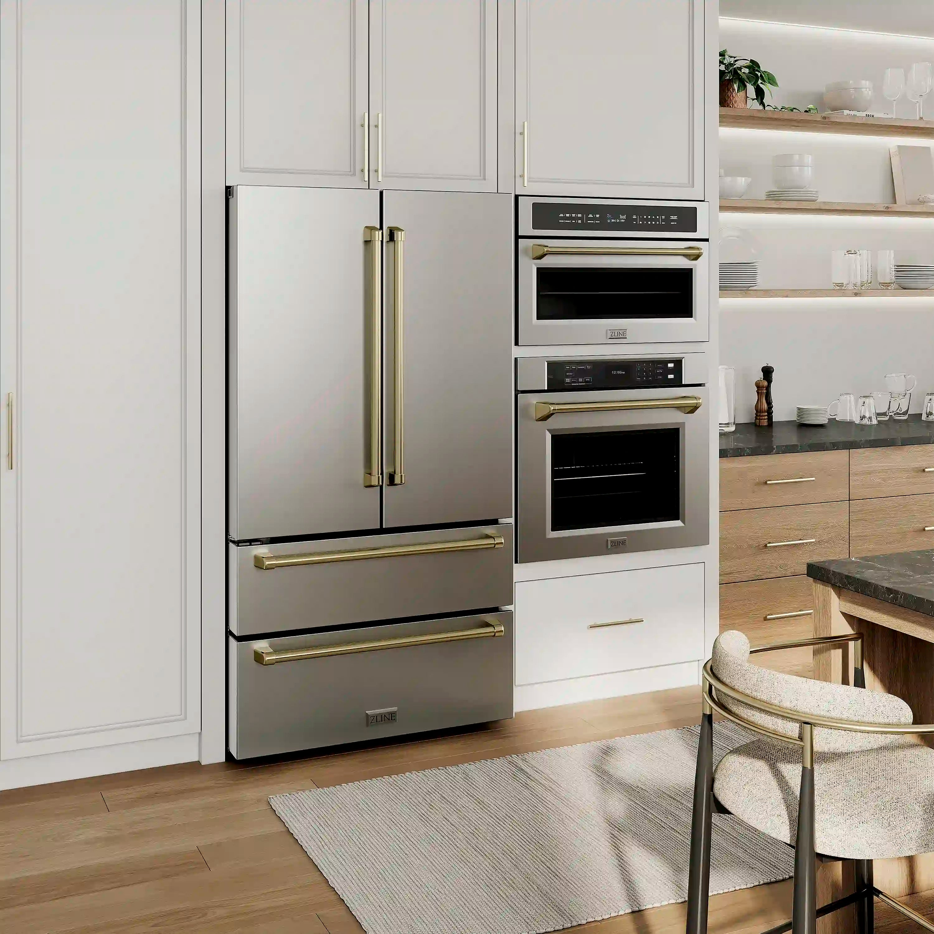 Stacked stainless steel wall ovens with champagne bronze handles in a modern kitchen