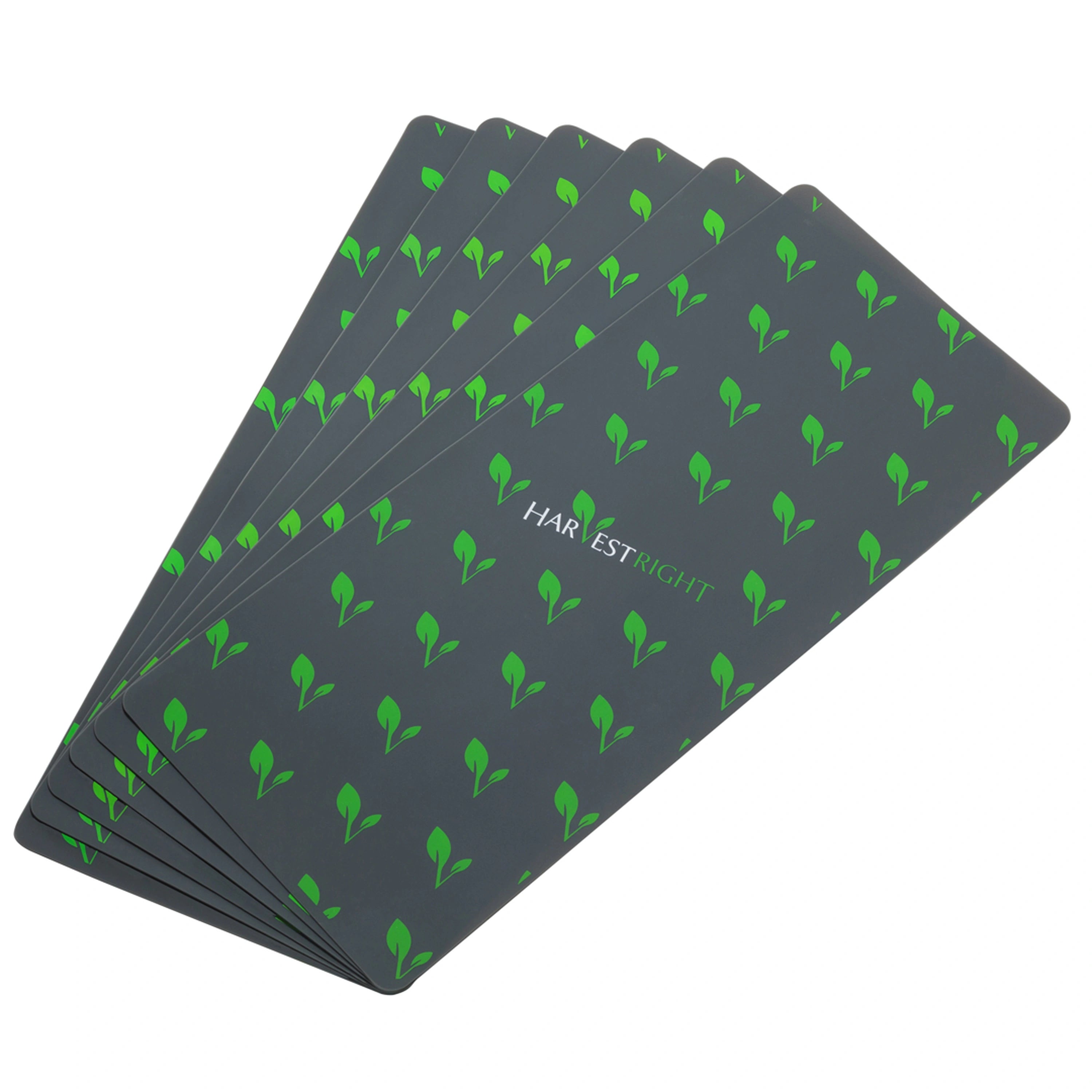 Stack of large silicone mats, dark gray with green leaf pattern