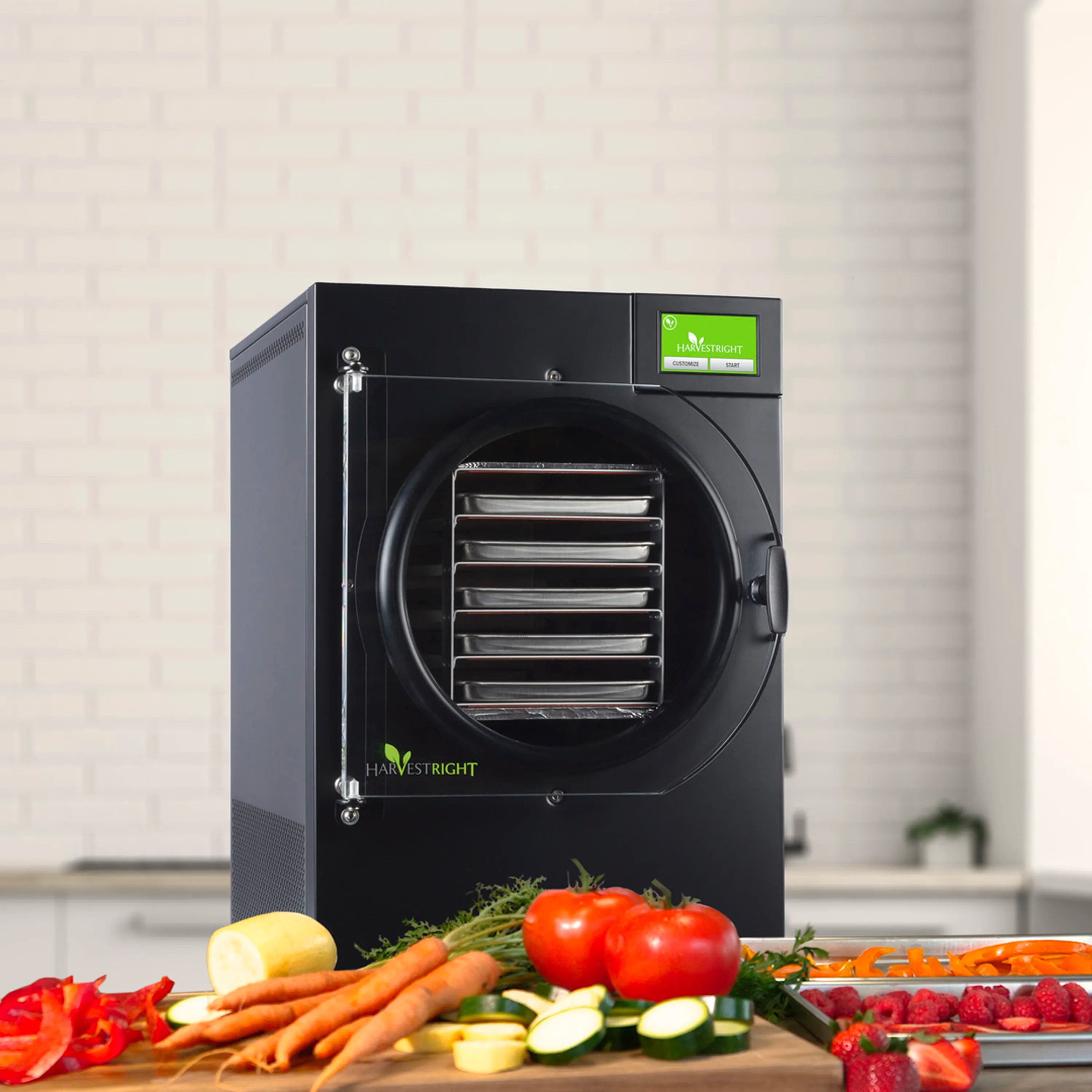 Black home freeze dryer with round chamber door and stainless trays