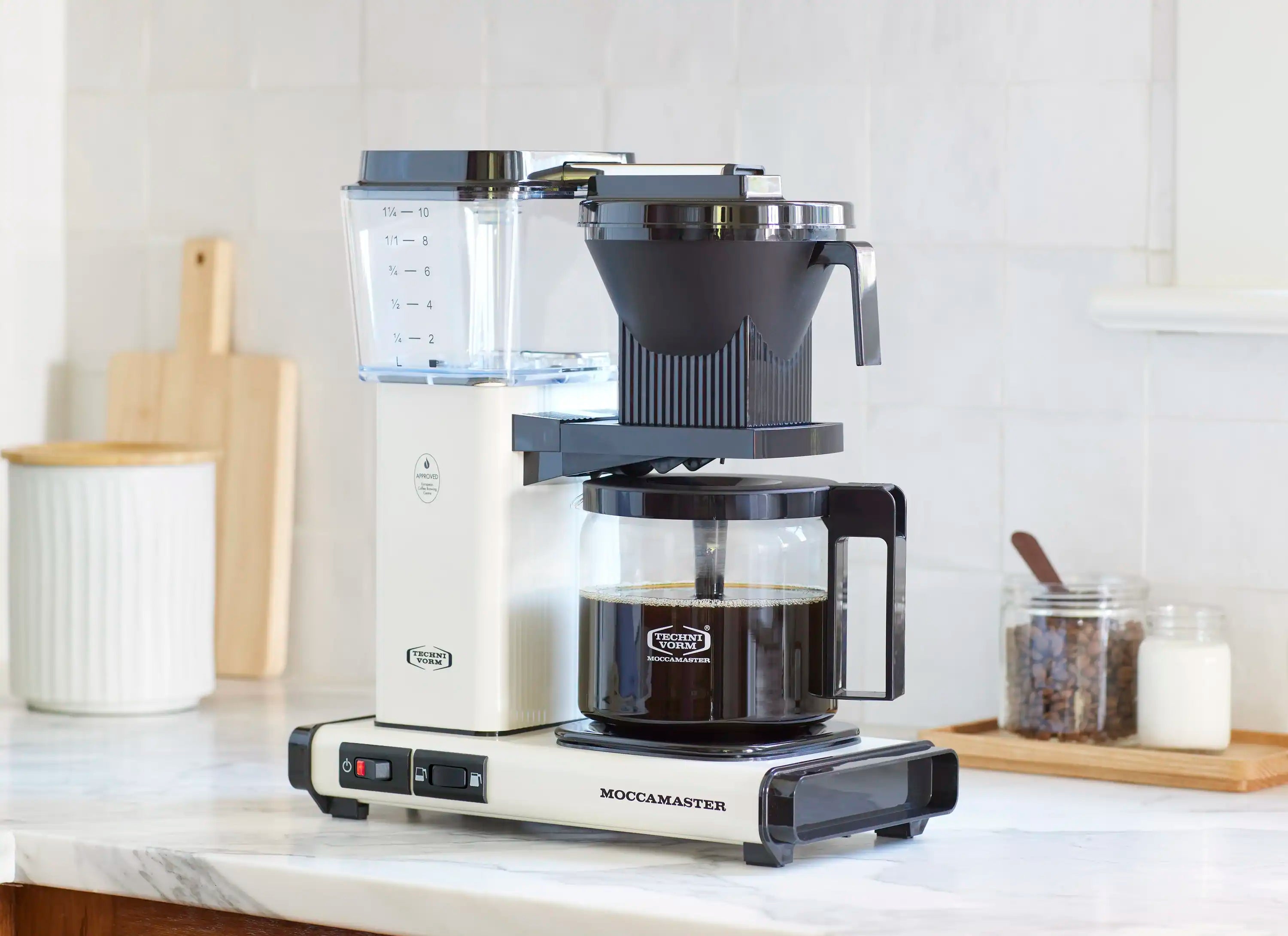 Moccamaster 10-cup coffee maker in off-white with glass carafe and drip-stop, front view