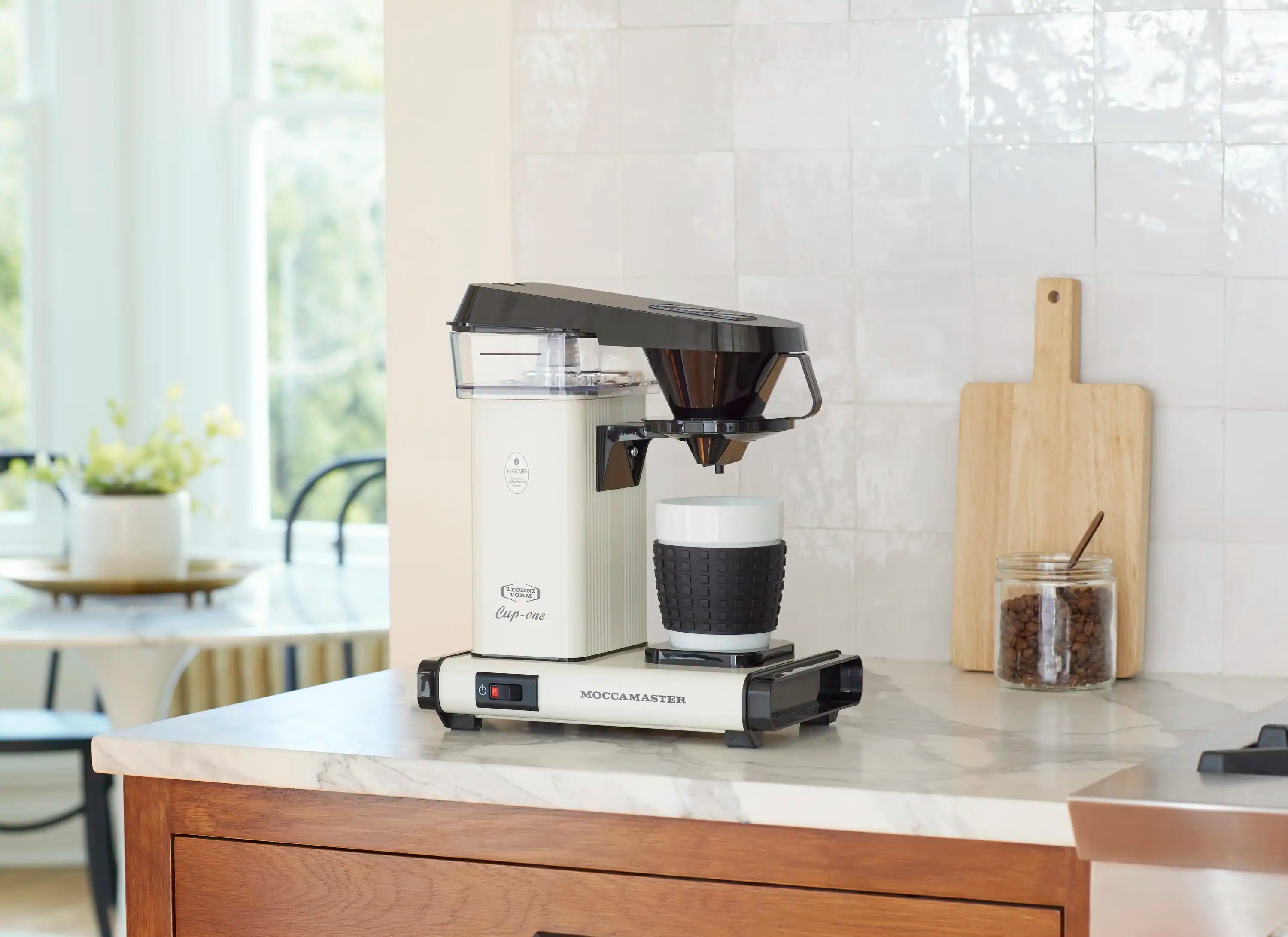 Off-white Moccamaster Cup-One single coffee maker on countertop with black filter and cup