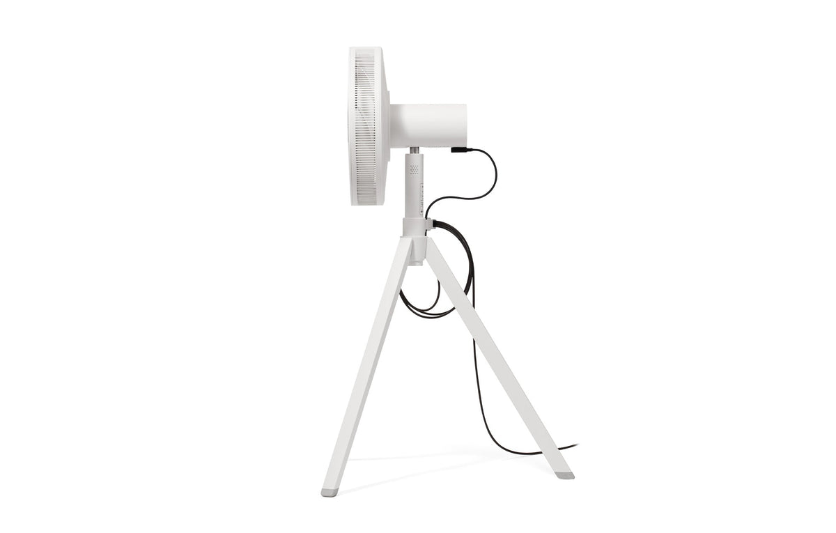 White 12-inch portable fan side view on tripod with power cord