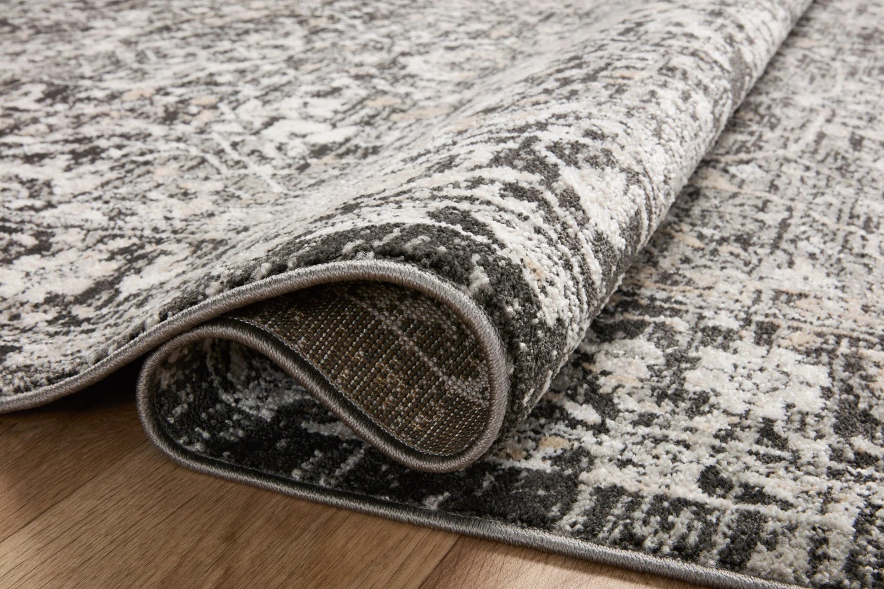 Charcoal and silver traditional rug edge with tightly bound short pile