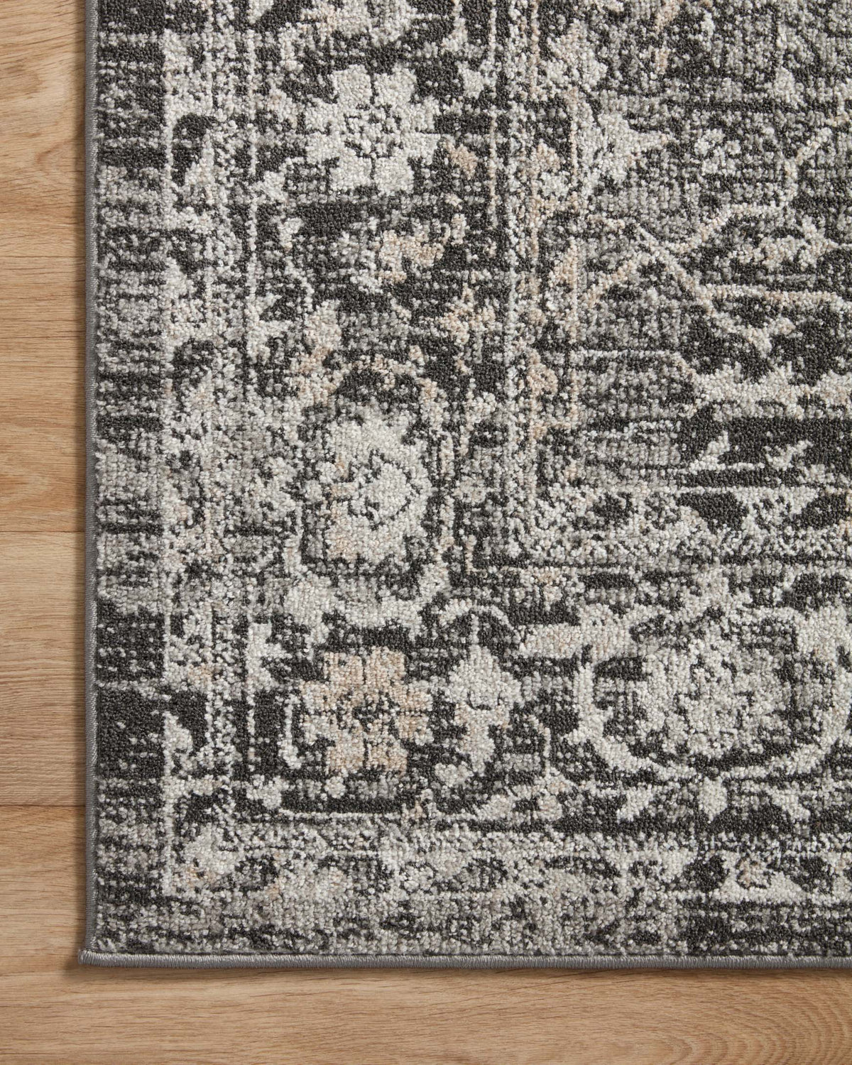 Charcoal and silver vintage-style rug with intricate damask pattern