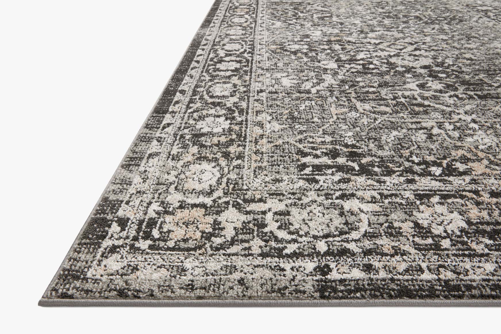 Traditional charcoal and silver accent rug with ornate distressed border pattern
