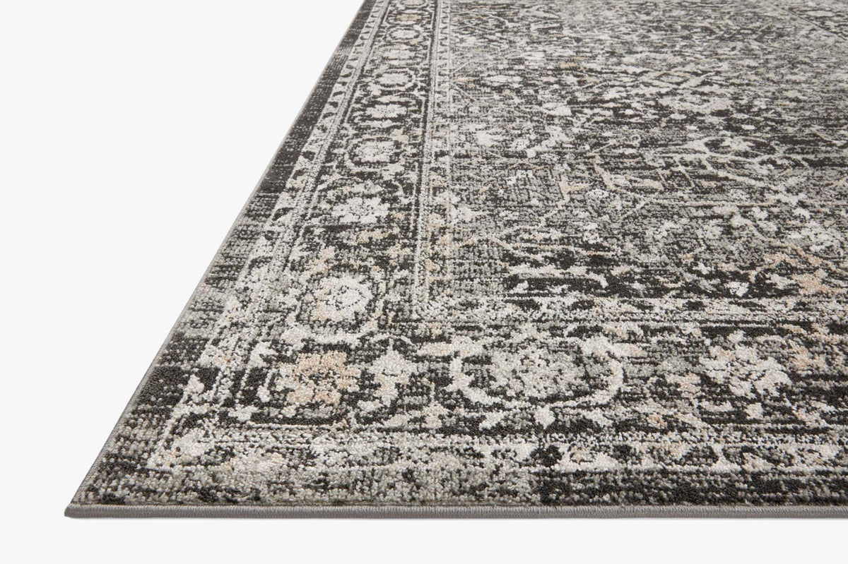 Charcoal runner rug with distressed silver patterned border and ornate medallion design