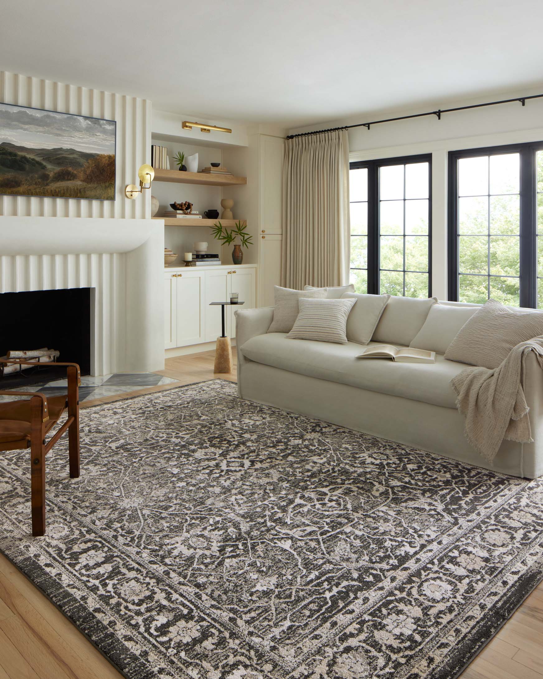 Charcoal and silver traditional area rug with distressed medallion and border