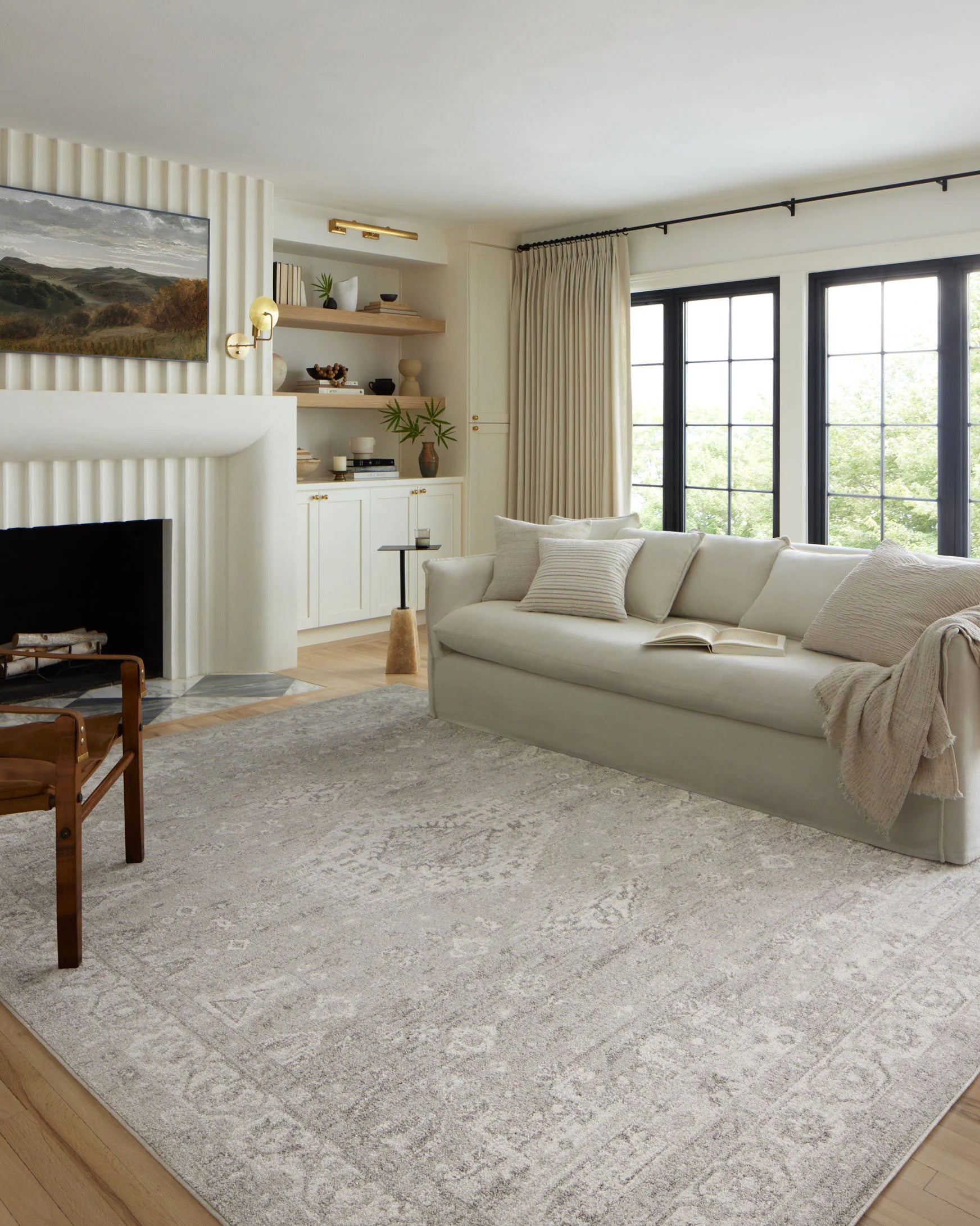 Traditional area rug with distressed silver-gray and ivory pattern, rectangular shape.
