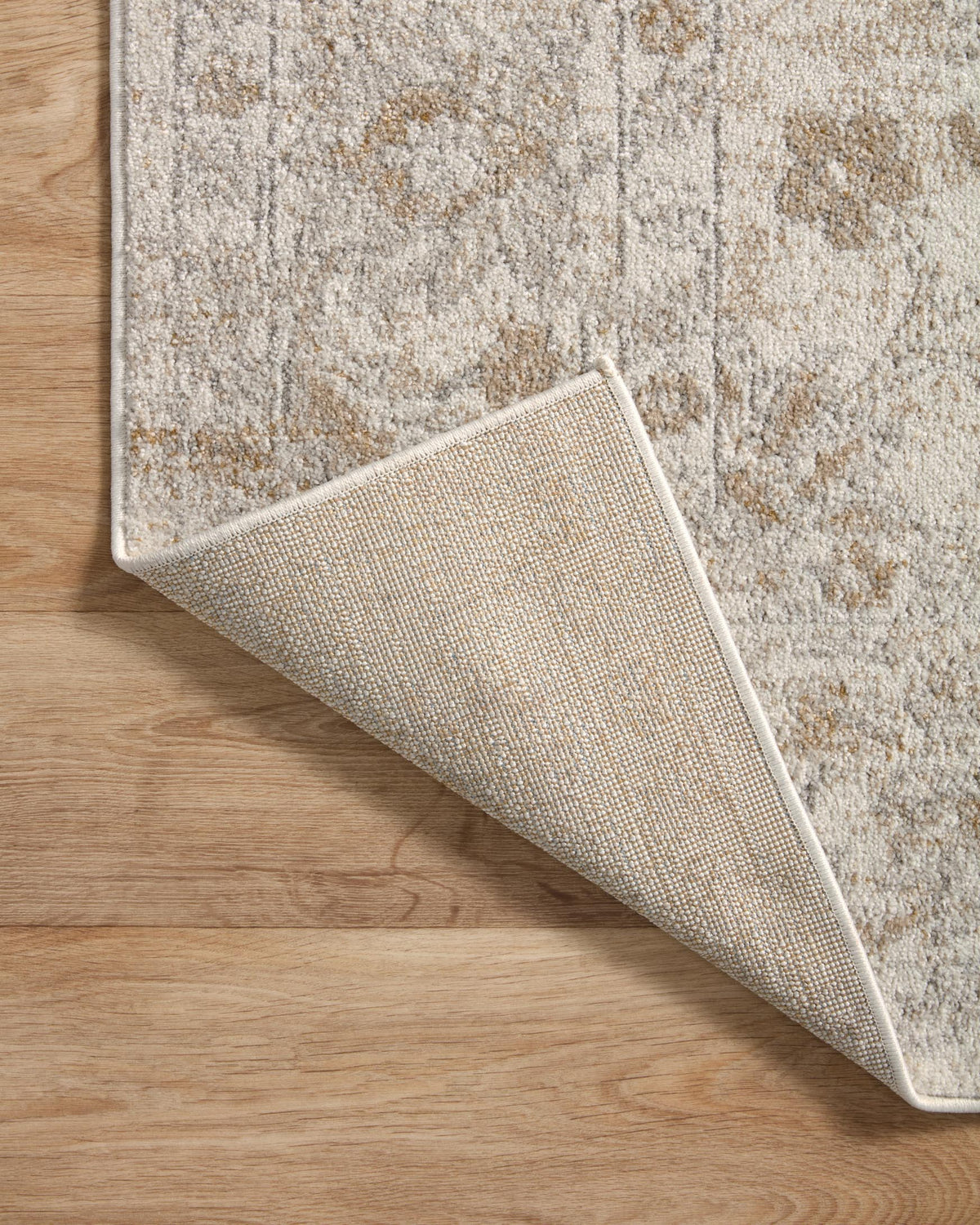 Traditional accent rug edge detail with folded corner showing tight binding