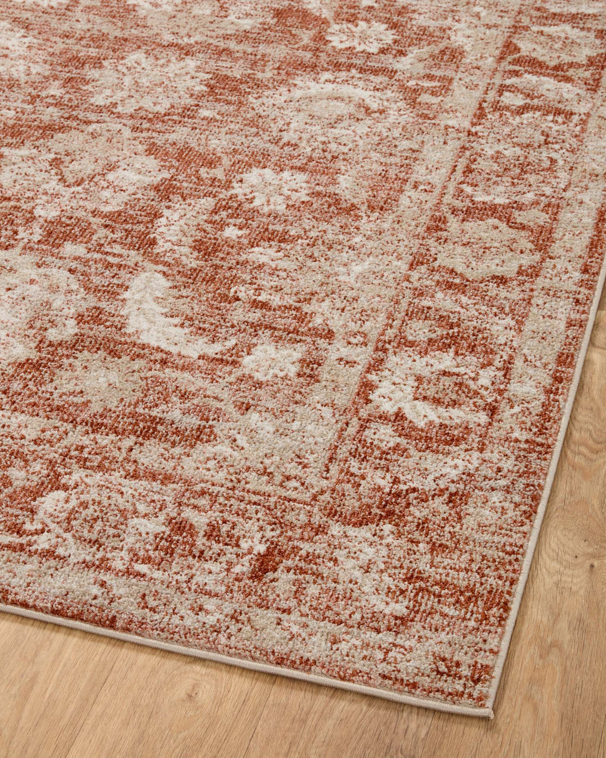 Rust and ivory distressed traditional area rug with geometric motifs and border trim