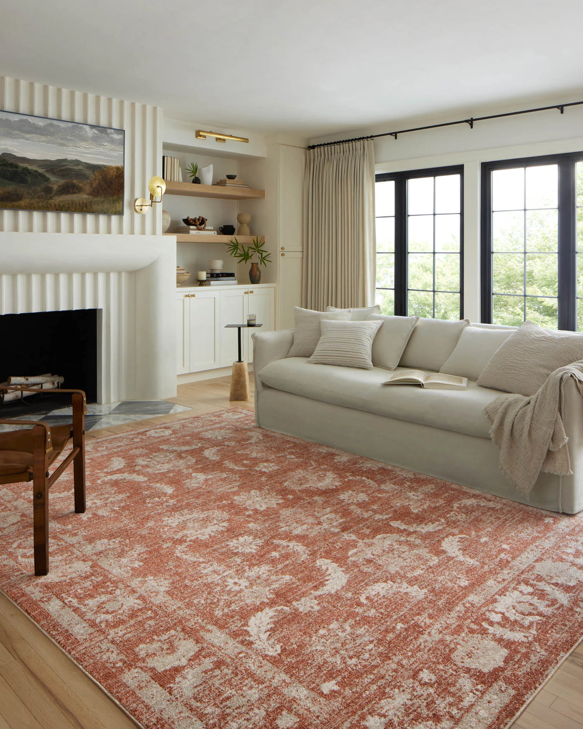 Rust and ivory traditional area rug spread across living room floor