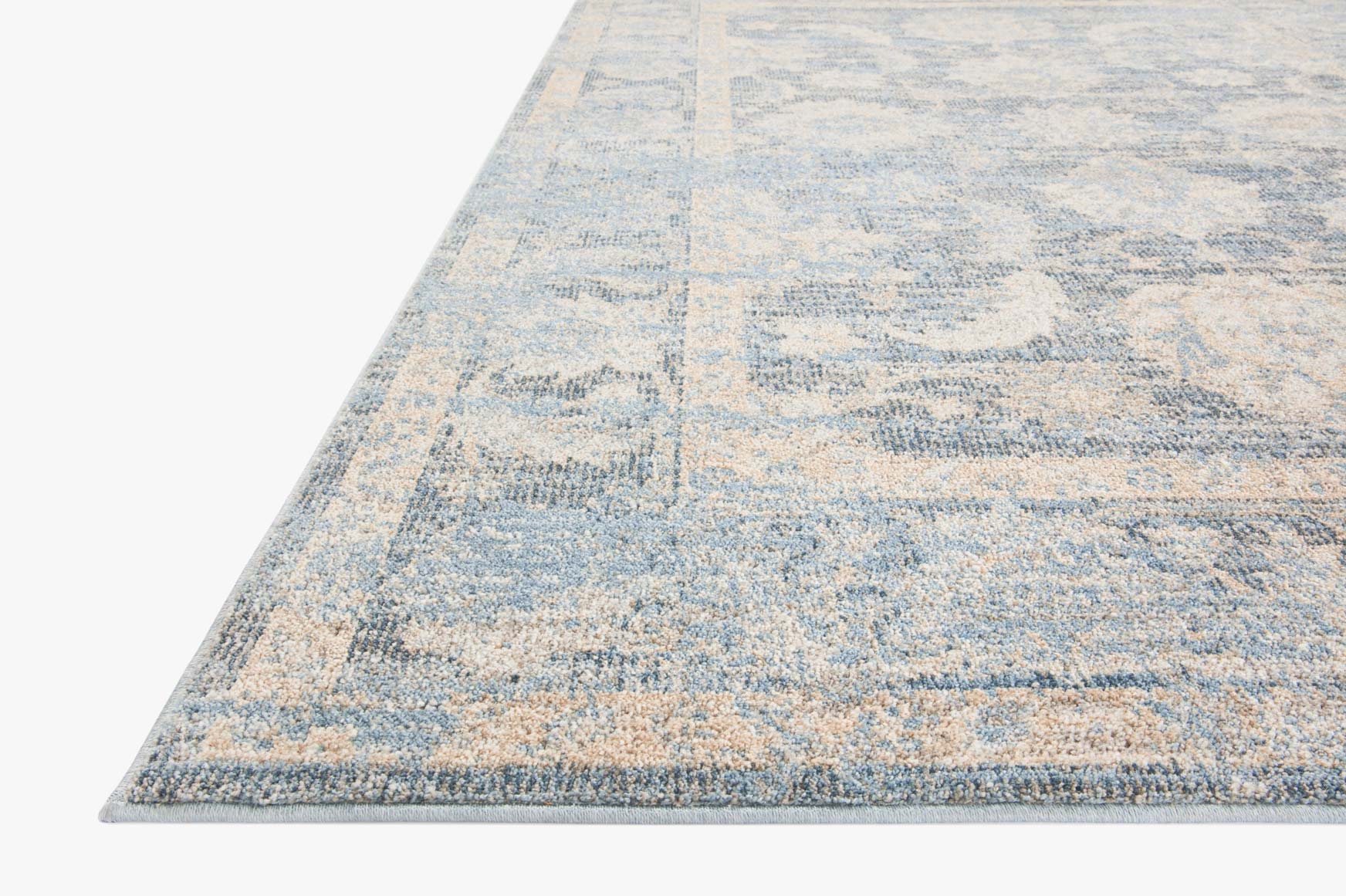 Sky-blue and beige traditional area rug with distressed pattern and stitched border