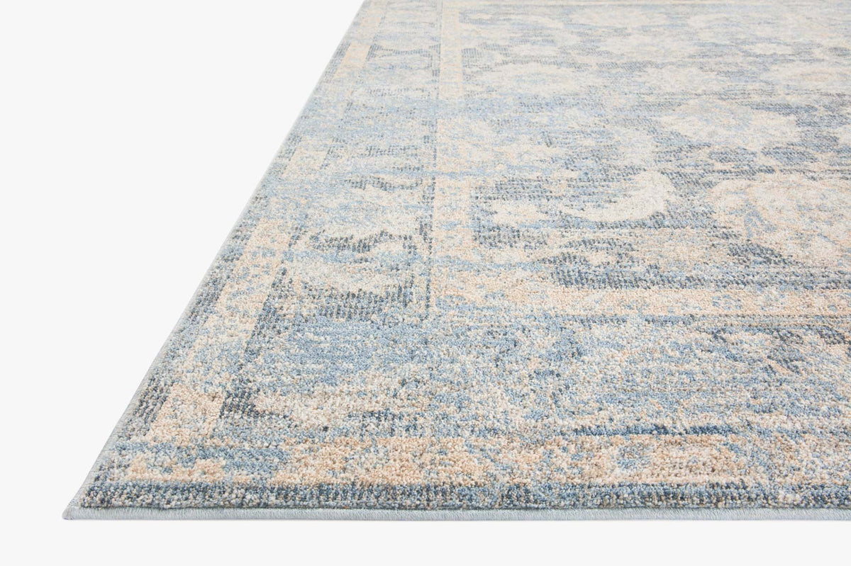 Sky and beige traditional area rug with distressed geometric patterns and low flatweave texture