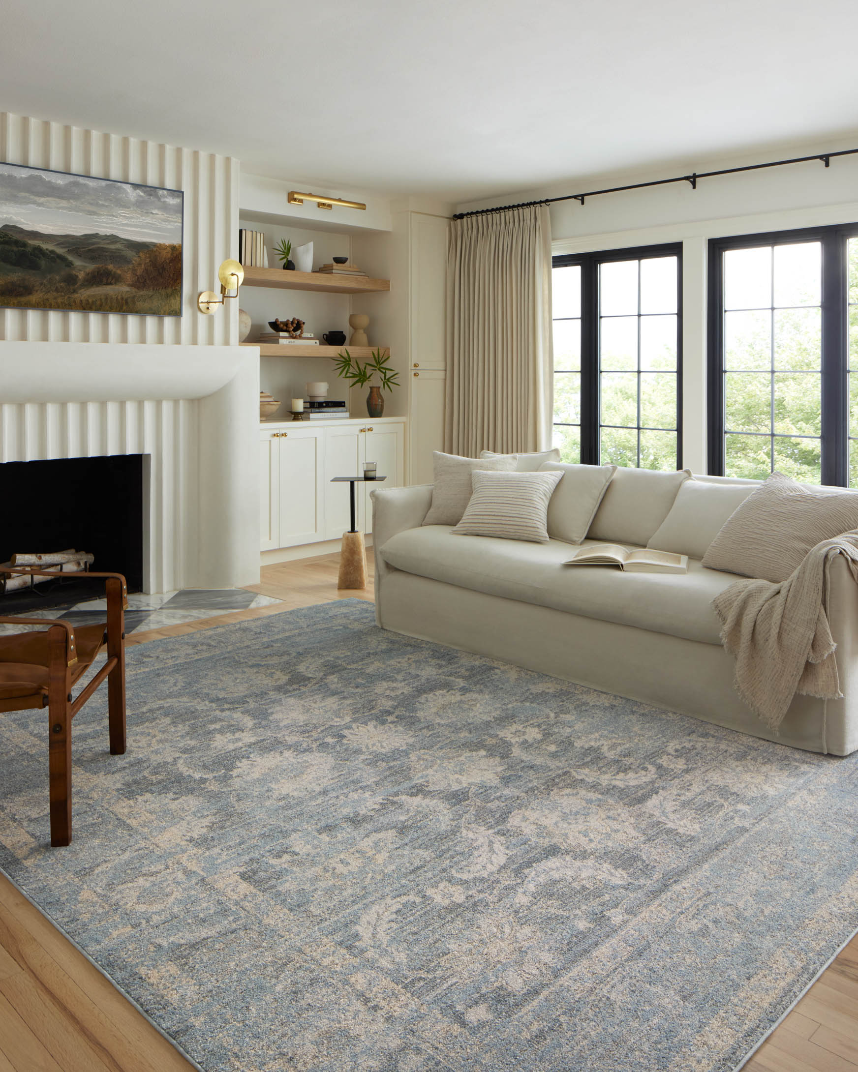Sky-blue accent rug with distressed traditional motif and bound edge, low-pile texture