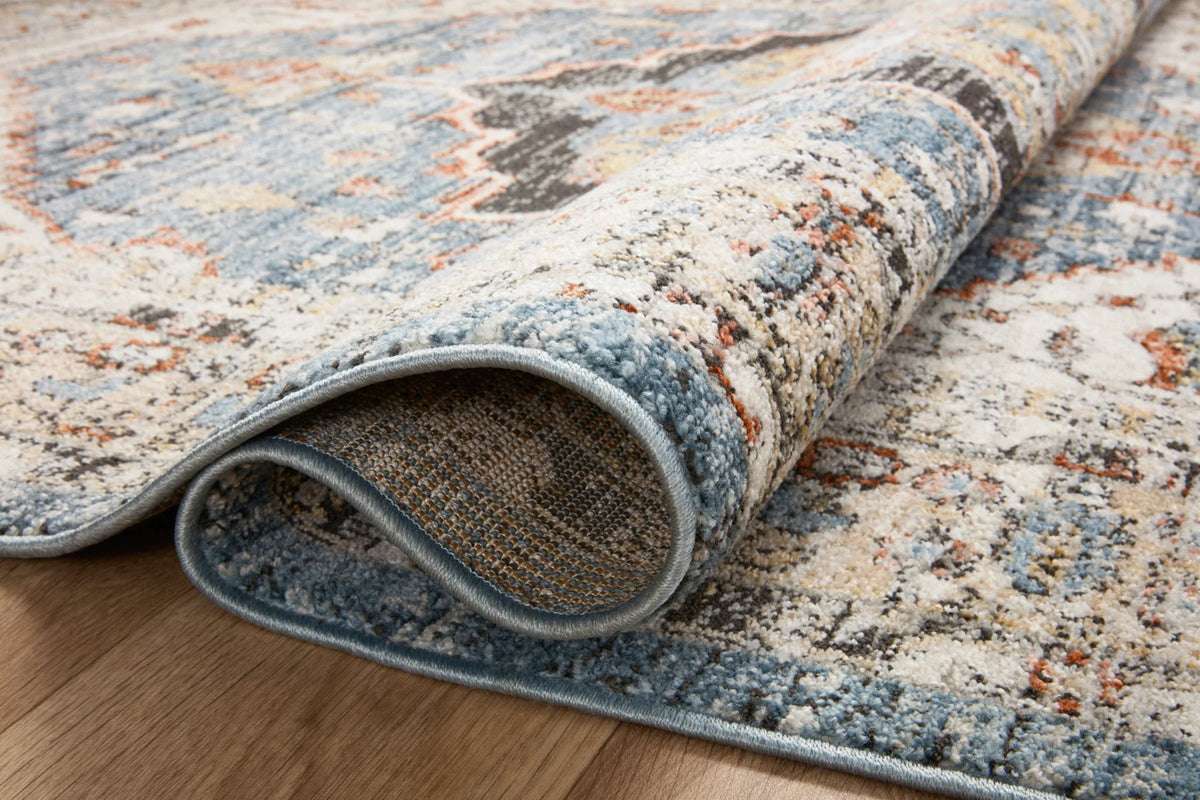 Round area rug detail: multicolor traditional weave with bound edge and low pile