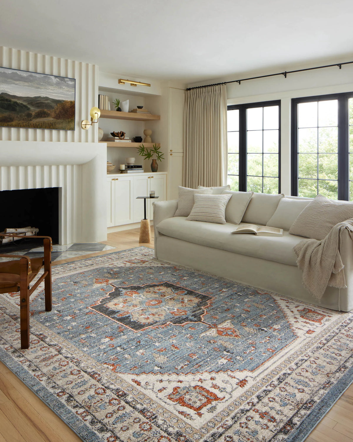 Traditional area rug, cream base with sky blue and rust medallion pattern on hardwood