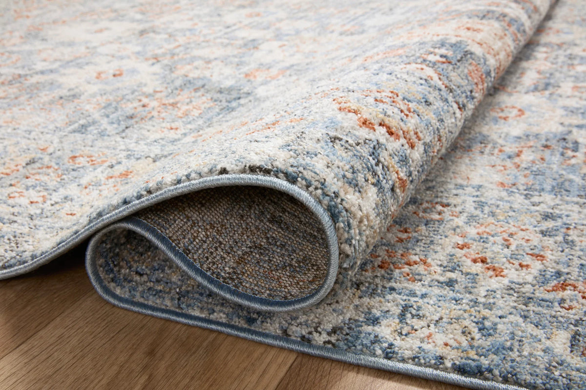Loloi traditional runner rug close-up, sky blue and ivory with rust speckled pattern