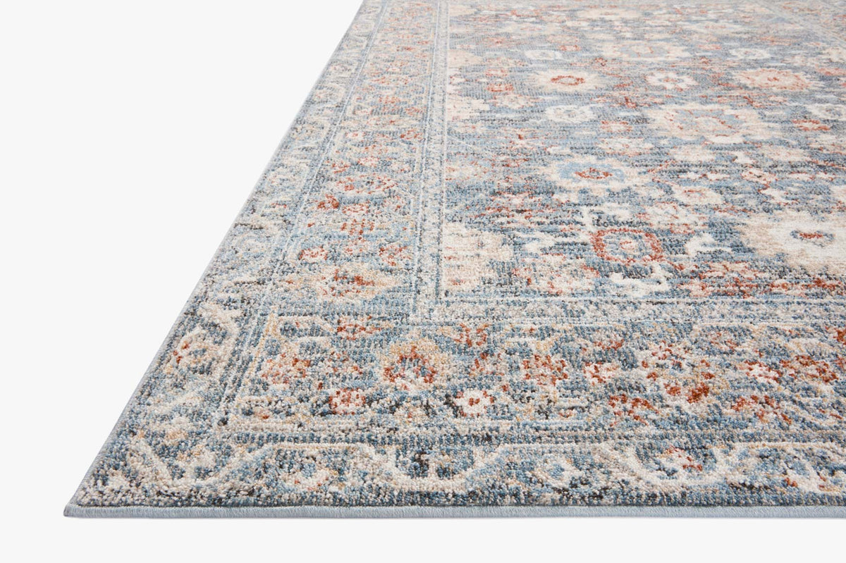 Traditional accent rug in sky blue with rust-orange and cream distressed pattern border