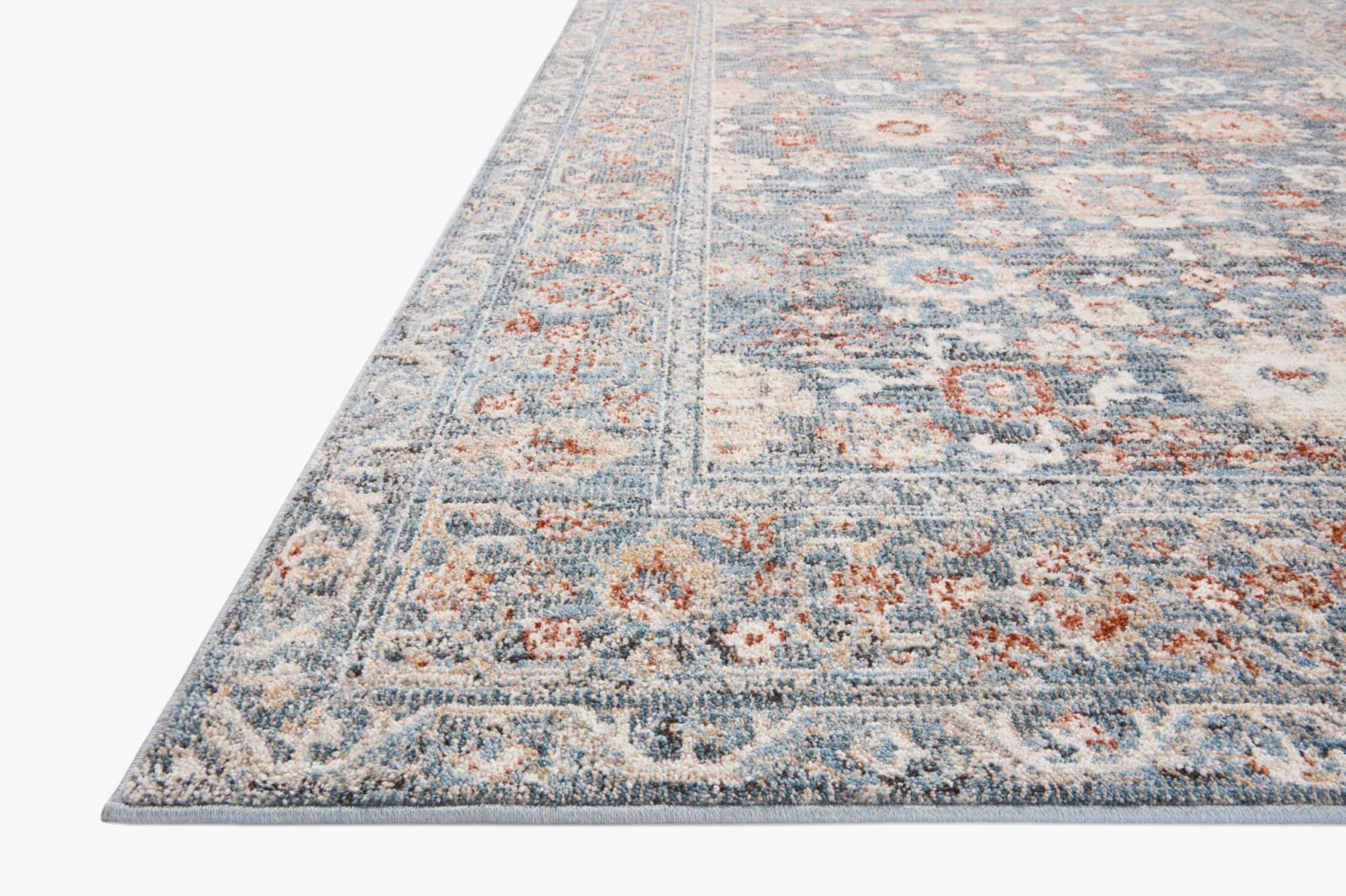 Traditional runner rug with sky-blue base and rust-orange motifs, distressed pattern.